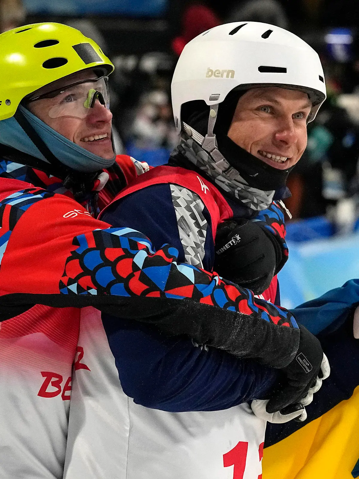 Bronze medal winner Ilia Burov, of the Russian Olympic Committee, left, hugs silver medal winner Ukraine's Oleksandr Abramenko as they celebrate after the men's aerials finals at the 2022 Winter Olympics, Wednesday, Feb. 16, 2022, in Zhangjiakou, China. (AP Photo/Gregory Bull)