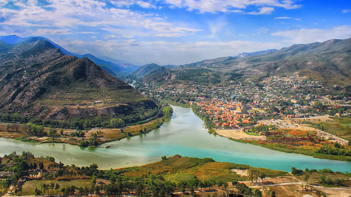 View of the merger of two rivers Kura or Mtkvari and Aragvi into one. The ancient capital of Georgia - Mtskheta right . Beautiful view of the city Mtskheta