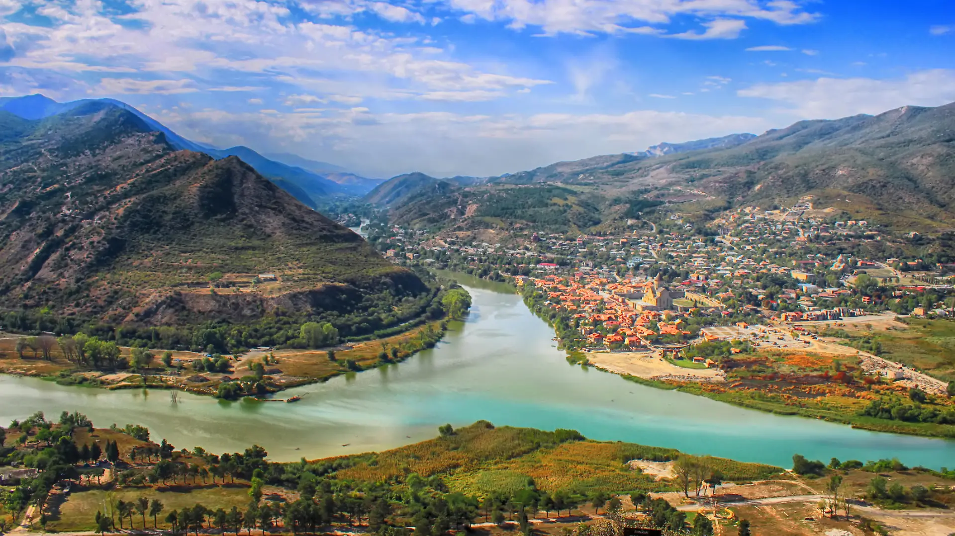 View of the merger of two rivers Kura or Mtkvari and Aragvi into one. The ancient capital of Georgia - Mtskheta right . Beautiful view of the city Mtskheta
