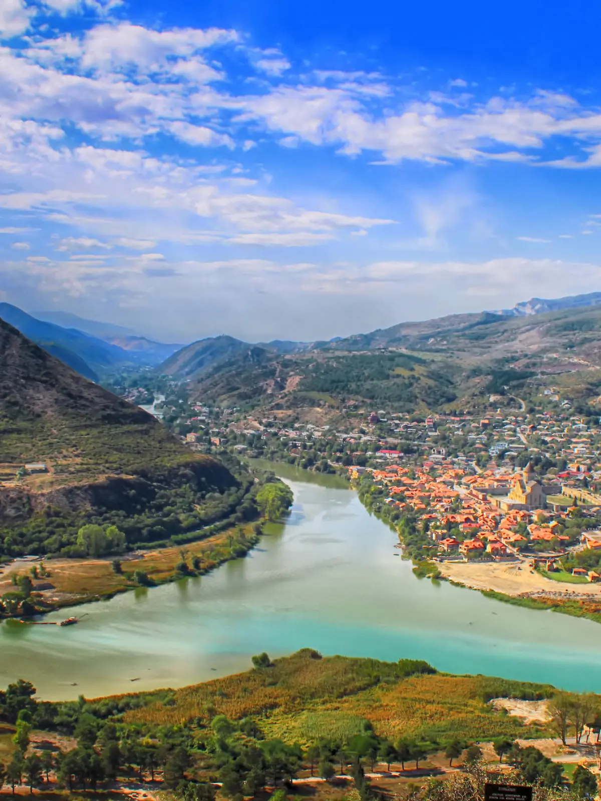 View of the merger of two rivers Kura or Mtkvari and Aragvi into one. The ancient capital of Georgia - Mtskheta right . Beautiful view of the city Mtskheta