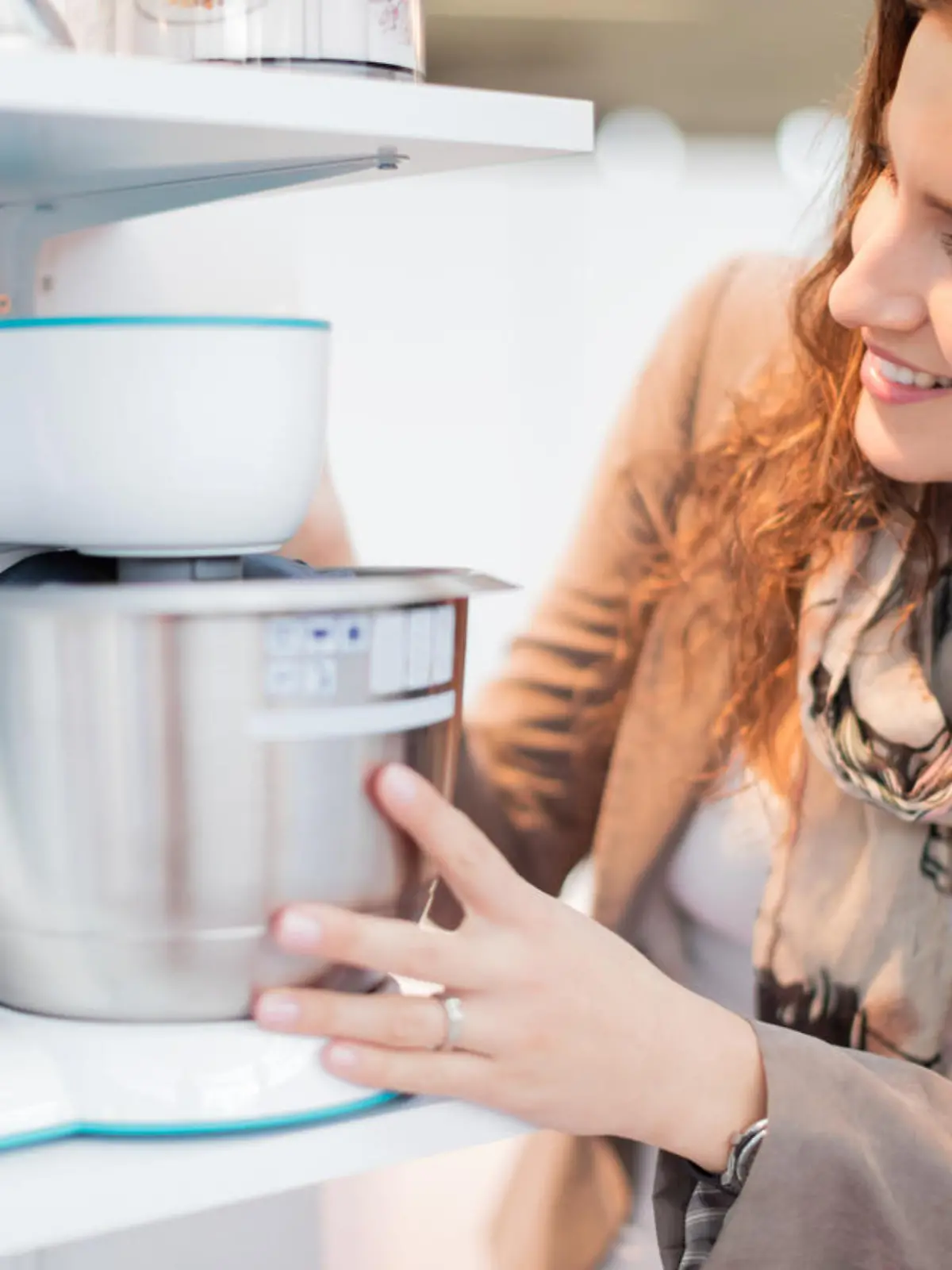 Smiling woman choosing perfect food processor