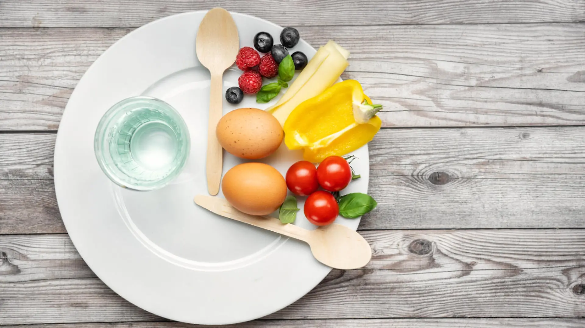 Interval fasting diet. Intermittent fasting concept represented with a plate and products on gray background. Healthy lifestyle. Fat loss concept. Top view