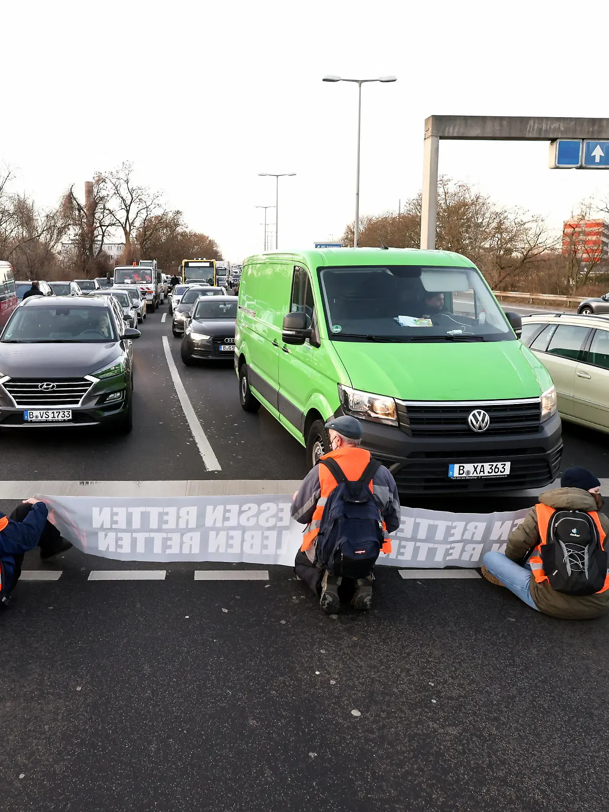 "Letzte Generation" (Last Generation) activists block the exit of a highway to protest against food waste and in support of an agricultural change to reduce greenhouse gas emissions, in Berlin, Germany, February 14, 2022. REUTERS/Christian Mang