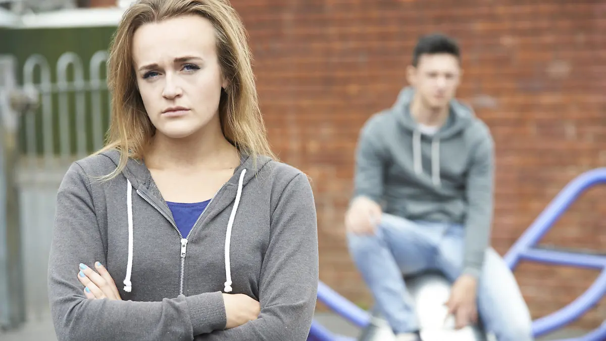 Portrait Of Unhappy Teenage Couple In Urban Setting