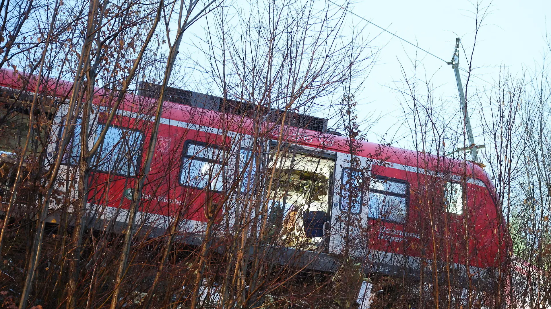 15.02.2022, Bayern, Schäftlarn: Der Triebkopf einer S-Bahn steht an der Unfallstelle auf dem Bahndamm neben dem Gleis. Bei dem Frontalzusammenstoß zweier S-Bahnen im Landkreis München sind am Montag (14.02.2022) ein Mensch getötet und 18 verletzt worden. Foto: Matthias Balk/dpa +++ dpa-Bildfunk +++