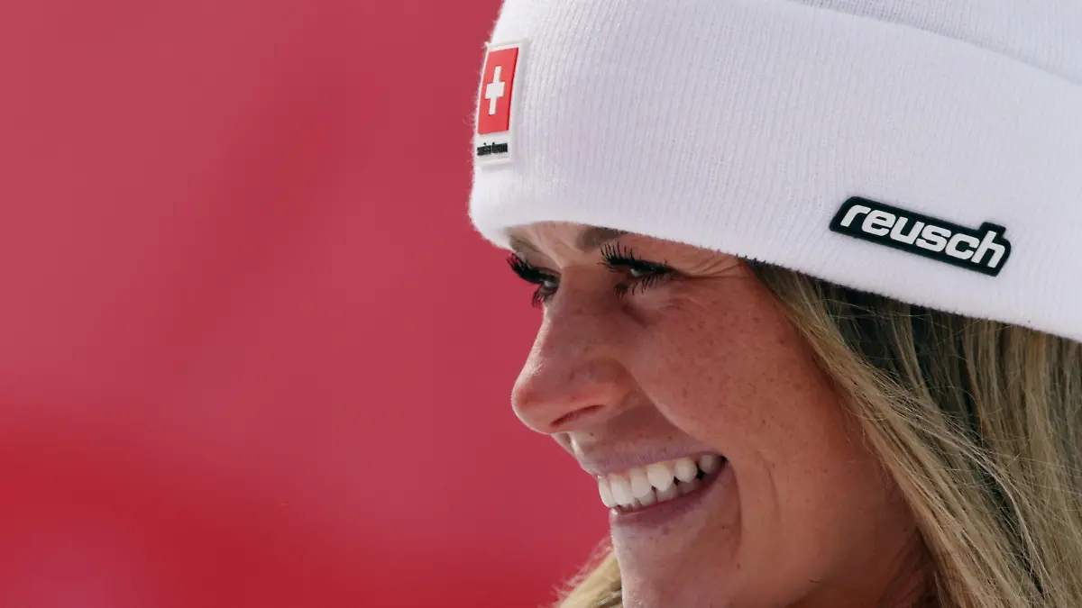 2022 Beijing Olympics - Victory Ceremony - Alpine Skiing - Women's Downhill - National Alpine Skiing Centre, Yanqing district, Beijing, China - February 15, 2022. Gold Medallist Corinne Suter of Switzerland celebrates during the victory ceremony. REUTERS/Jorge Silva
