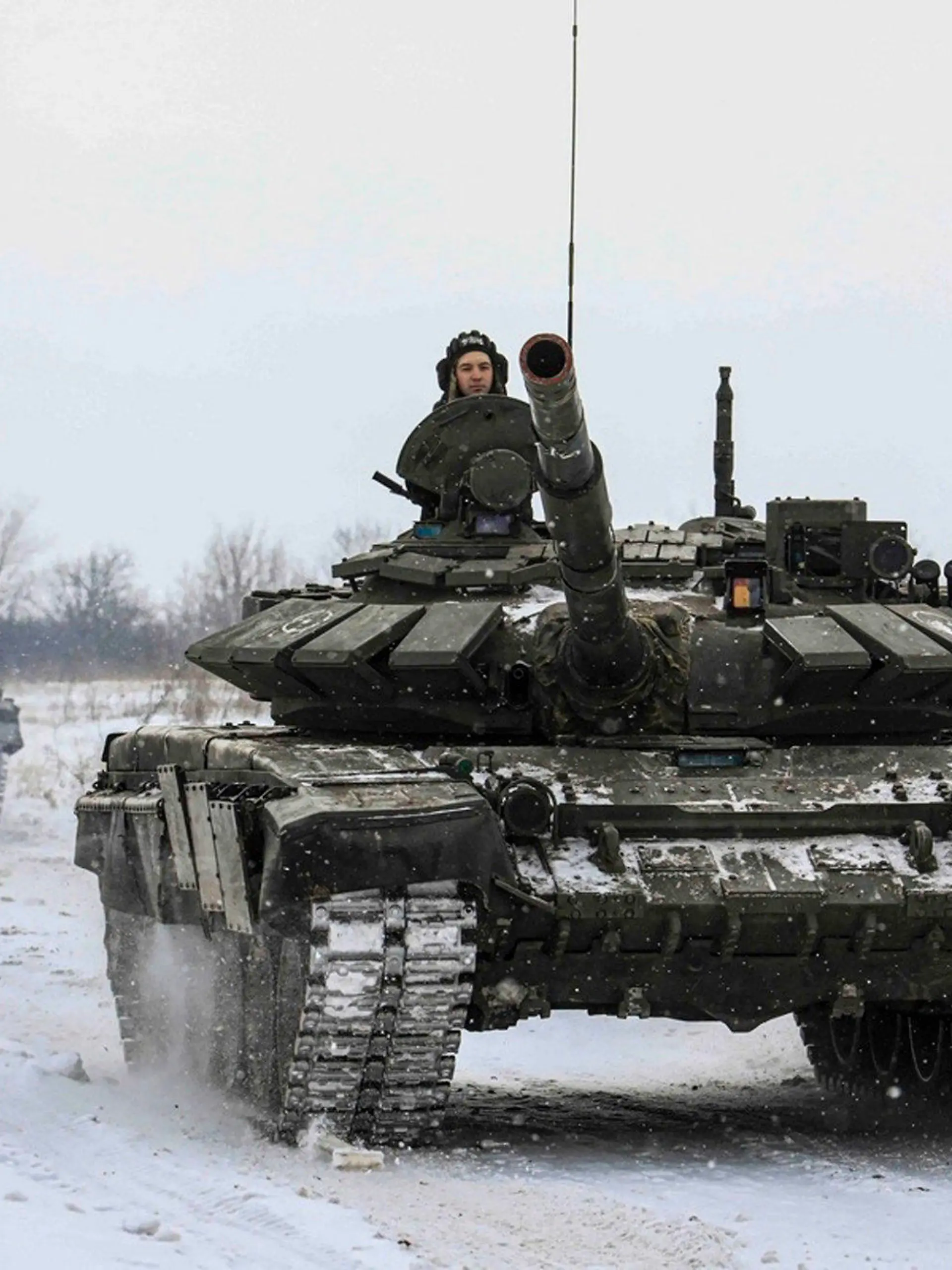HANDOUT - 14.02.2022, Russland, ---: Auf diesem vom Pressedienst des russischen Verteidigungsministeriums zur Verfügung gestellten Foto rollen russische Panzer, während militärischer Übungen in der Region Leningrad, über das Feld. Foto: Uncredited/Russian Defense Ministry Press Service/AP/dpa - ACHTUNG: Nur zur redaktionellen Verwendung und nur mit vollständiger Nennung des vorstehenden Credits +++ dpa-Bildfunk +++