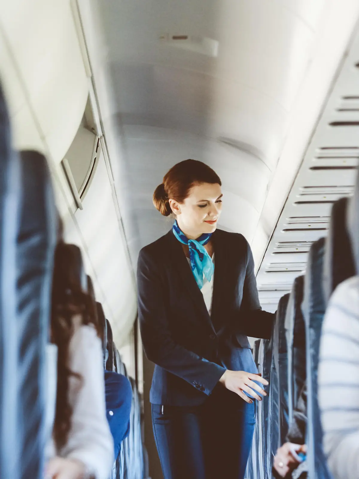Beautiful air stewardess inside an airplane.