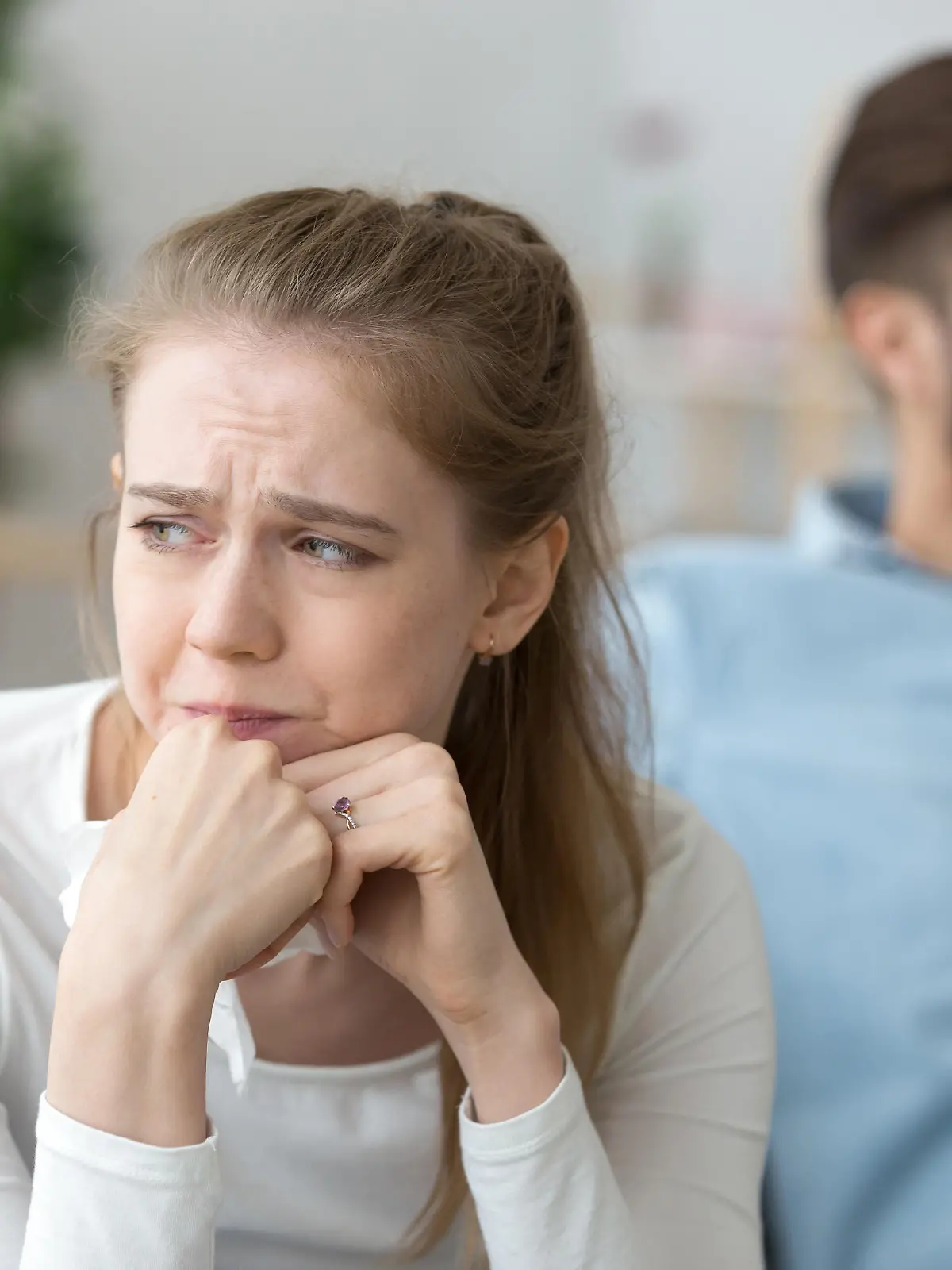Close up of sad woman cry after fight with husband, unhappy young wife feel lonely having disagreement with spouse, upset female look in distance thinking of relationships problems or breakup