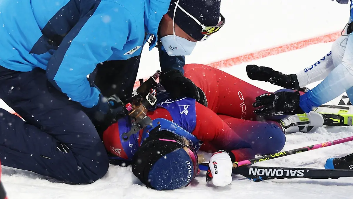 2022 Beijing Olympics - Biathlon - Women's 10km Pursuit - National Biathlon Centre, Zhangjiakou, China - February 13, 2022. Ingrid Landmark Tandrevold of Norway is assisted after the race. REUTERS/Kim Hong-Ji