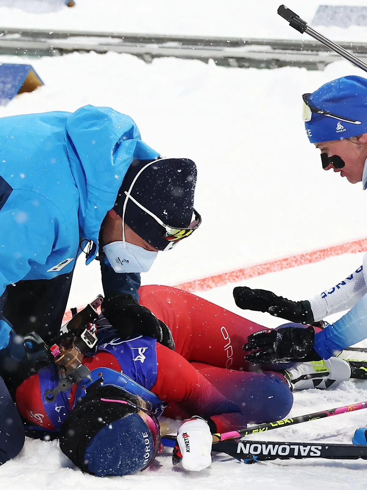 2022 Beijing Olympics - Biathlon - Women's 10km Pursuit - National Biathlon Centre, Zhangjiakou, China - February 13, 2022. Ingrid Landmark Tandrevold of Norway is assisted after the race. REUTERS/Kim Hong-Ji