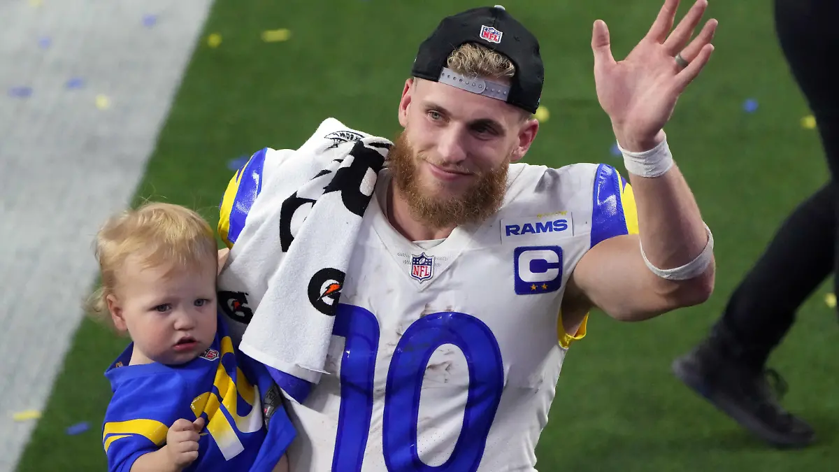 Feb 13, 2022; Inglewood, California, USA; Los Angeles Rams wide receiver Cooper Kupp (10) celebrates holds his son Cypress Stellar after the Rams defeated the Cincinnati Bengals in Super Bowl LVI at SoFi Stadium. Mandatory Credit: Kirby Lee-USA TODAY Sports