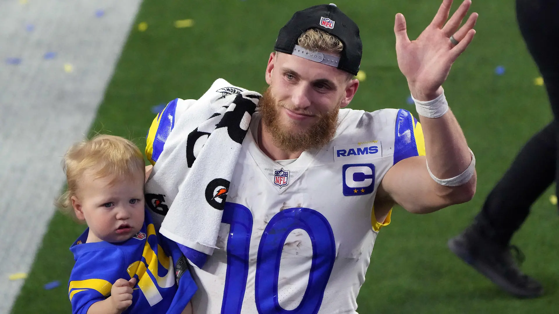 Feb 13, 2022; Inglewood, California, USA; Los Angeles Rams wide receiver Cooper Kupp (10) celebrates holds his son Cypress Stellar after the Rams defeated the Cincinnati Bengals in Super Bowl LVI at SoFi Stadium. Mandatory Credit: Kirby Lee-USA TODAY Sports