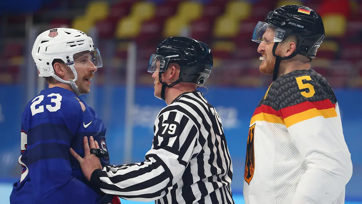 BEIJING, CHINA - FEBRUARY 13: The referee seperates Brian Cooper #23 of Team United States and Korbinian Holzer #5 of Team Germany during the Men's Ice Hockey Preliminary Round Group A match between Team United States and Team Germany on Day 9 of the Beijing 2022 Winter Olympic Games at Wukesong Sports Centre on February 13, 2022 in Beijing, China. (Photo by Elsa/Getty Images)