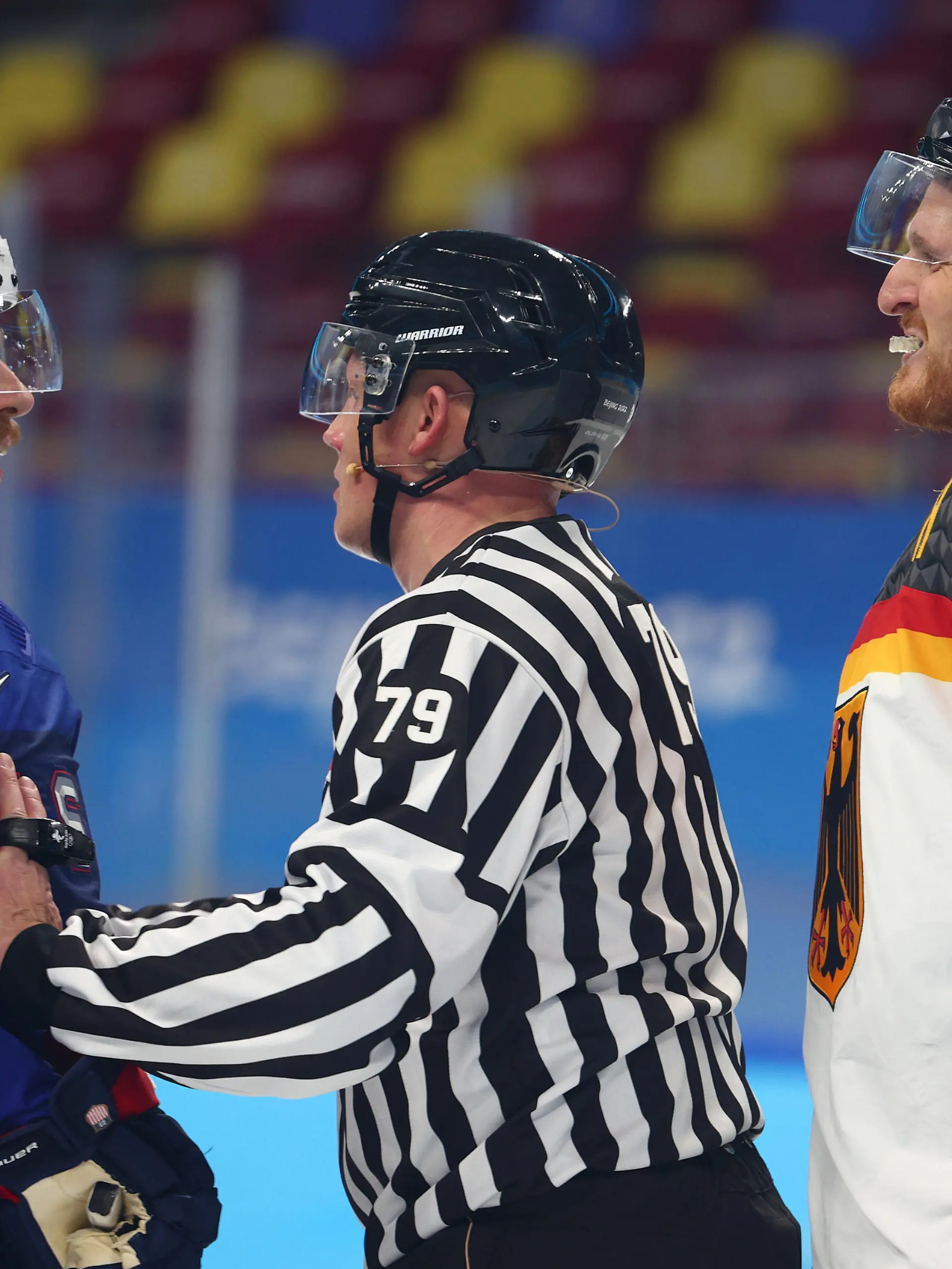 BEIJING, CHINA - FEBRUARY 13: The referee seperates Brian Cooper #23 of Team United States and Korbinian Holzer #5 of Team Germany during the Men's Ice Hockey Preliminary Round Group A match between Team United States and Team Germany on Day 9 of the Beijing 2022 Winter Olympic Games at Wukesong Sports Centre on February 13, 2022 in Beijing, China. (Photo by Elsa/Getty Images)