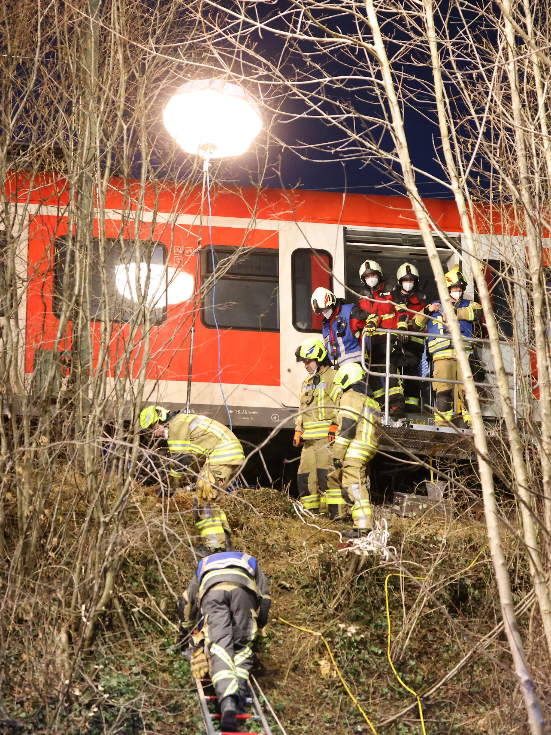 dpatopbilder - 14.02.2022, Bayern, Schäftlarn: Rettungskräfte arbeiten an der Unfallstelle. Beim Zusammenstoß zweier S-Bahnen im Landkreis München sind am Montag ein Mensch getötet und mehr als zehn verletzt worden. Es habe eine niedrige zweistellige Zahl an Verletzten gegeben, berichtete ein Sprecher des Münchner Polizeipräsidiums. Foto: Matthias Balk/dpa +++ dpa-Bildfunk +++