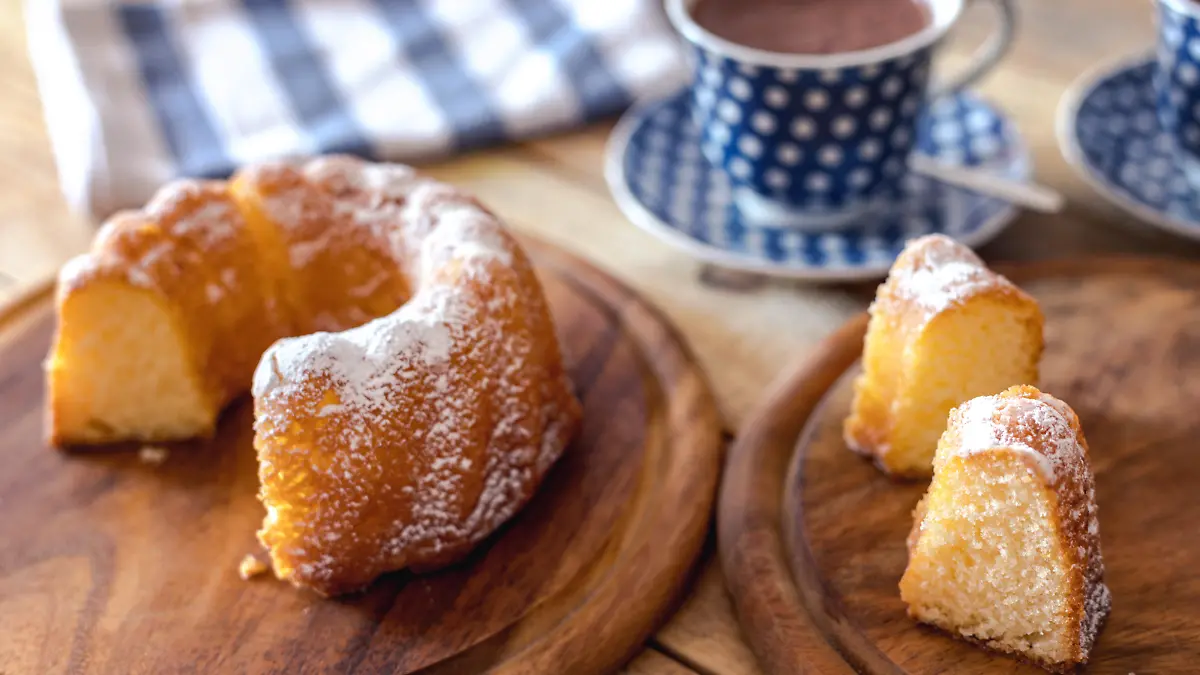Sweet breakfast, kuglof cake at plate with cups of hot chocolate