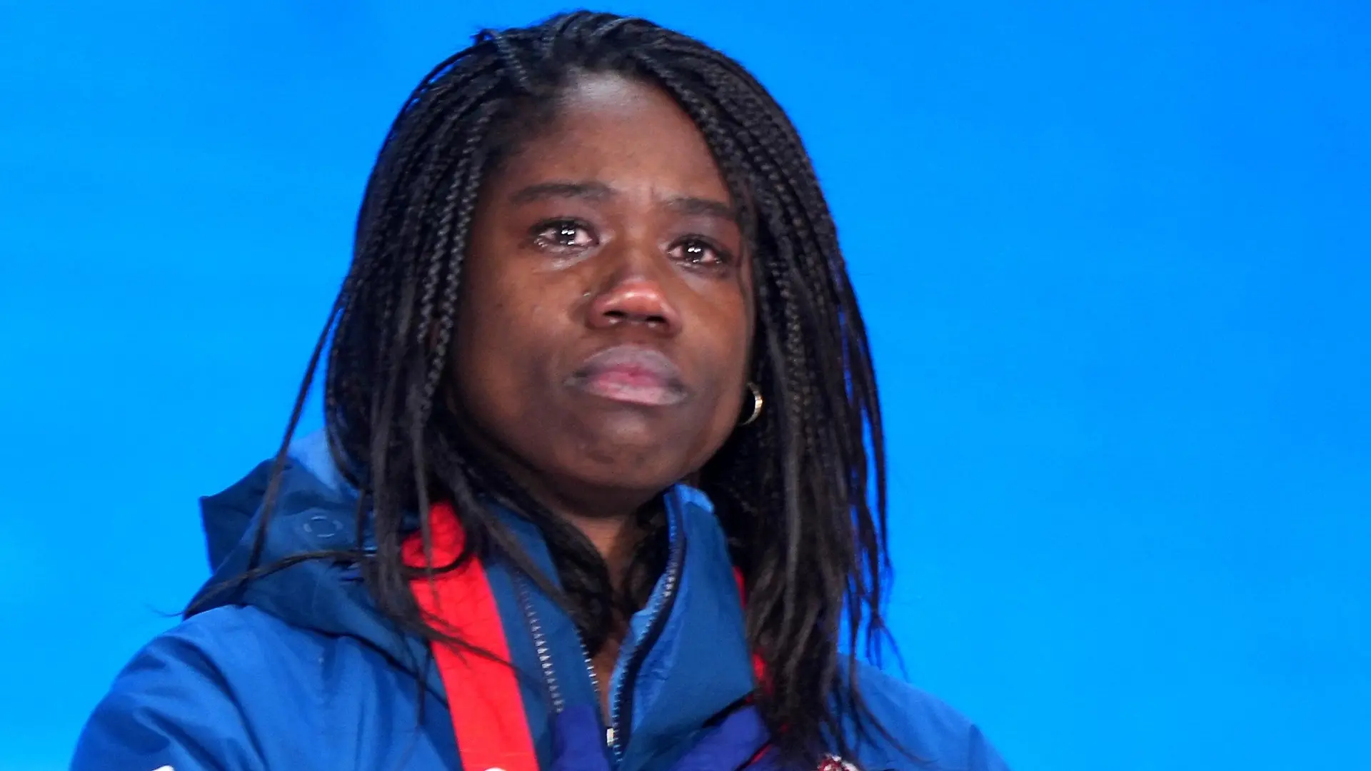 8114412 14.02.2022 Gold medalist Erin Jackson, of the United States, listens to national anthem during the medal ceremony for the speed skating women's 500 m event of the Beijing 2022 Winter Olympic Games at the Medals Plaza in Beijing, China. Alexander Vilf / Sputnik