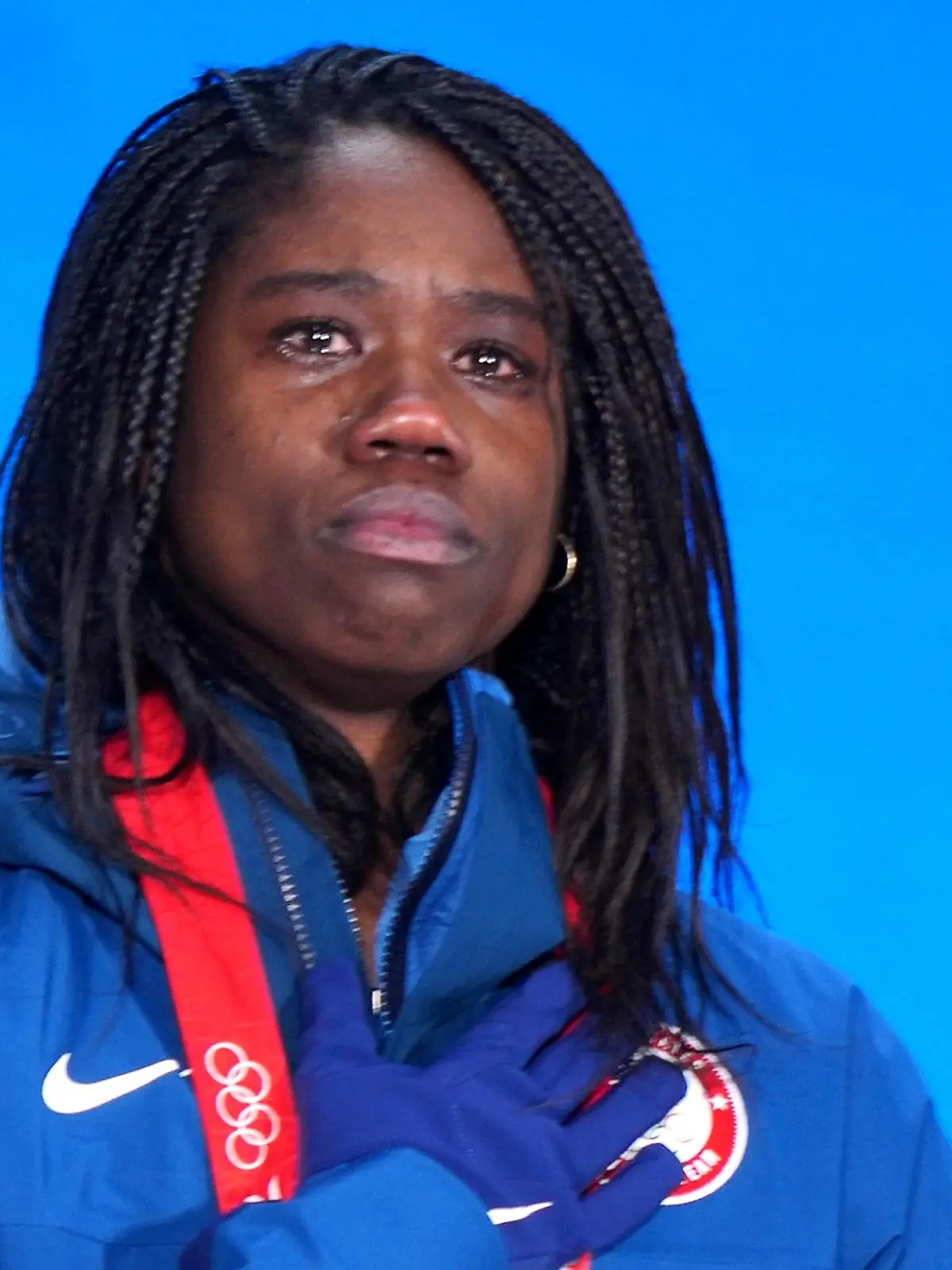 8114412 14.02.2022 Gold medalist Erin Jackson, of the United States, listens to national anthem during the medal ceremony for the speed skating women's 500 m event of the Beijing 2022 Winter Olympic Games at the Medals Plaza in Beijing, China. Alexander Vilf / Sputnik