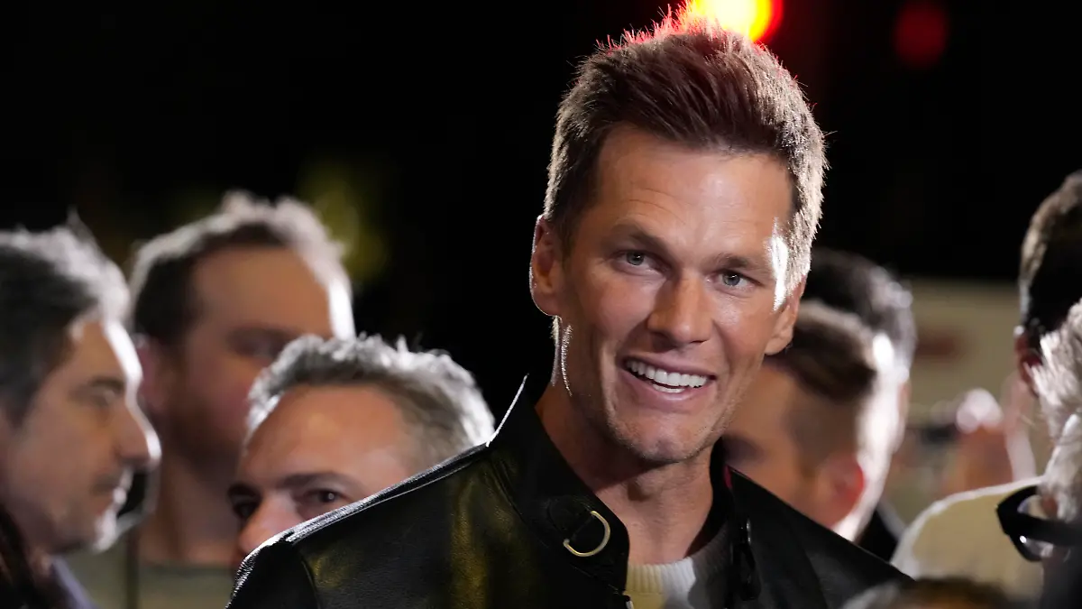 NFL quarterback Tom Brady, a cast member and producer of "80 for Brady," looks down the carpet at the premiere of the film, Tuesday, Jan. 31, 2023, at the Regency Village Theatre in Los Angeles. (AP Photo/Chris Pizzello)