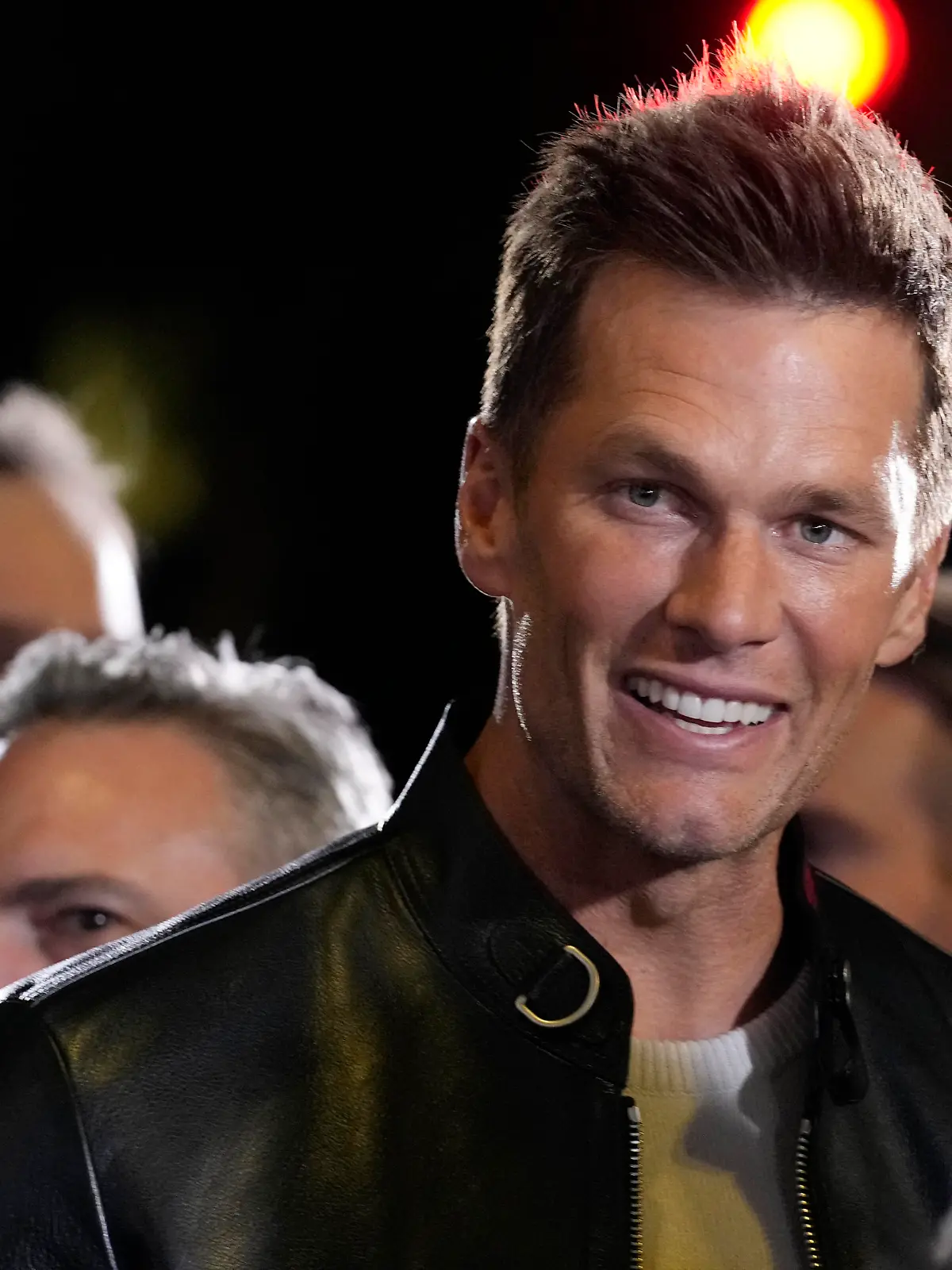 NFL quarterback Tom Brady, a cast member and producer of "80 for Brady," looks down the carpet at the premiere of the film, Tuesday, Jan. 31, 2023, at the Regency Village Theatre in Los Angeles. (AP Photo/Chris Pizzello)