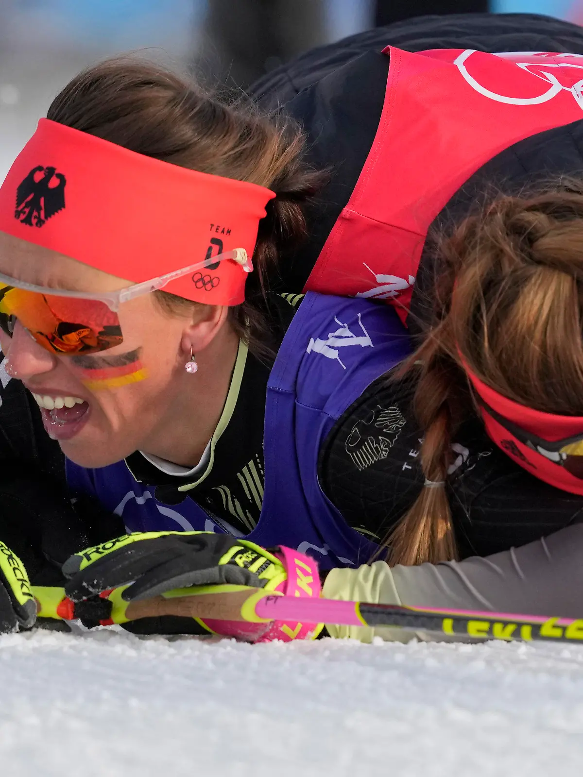 Katherine Sauerbrey, of Germany, right, embraces Sofie Krehl, of Germany, after finishing the women's 4 x 5km relay cross-country skiing competition at the 2022 Winter Olympics, Saturday, Feb. 12, 2022, in Zhangjiakou, China. (AP Photo/Aaron Favila)