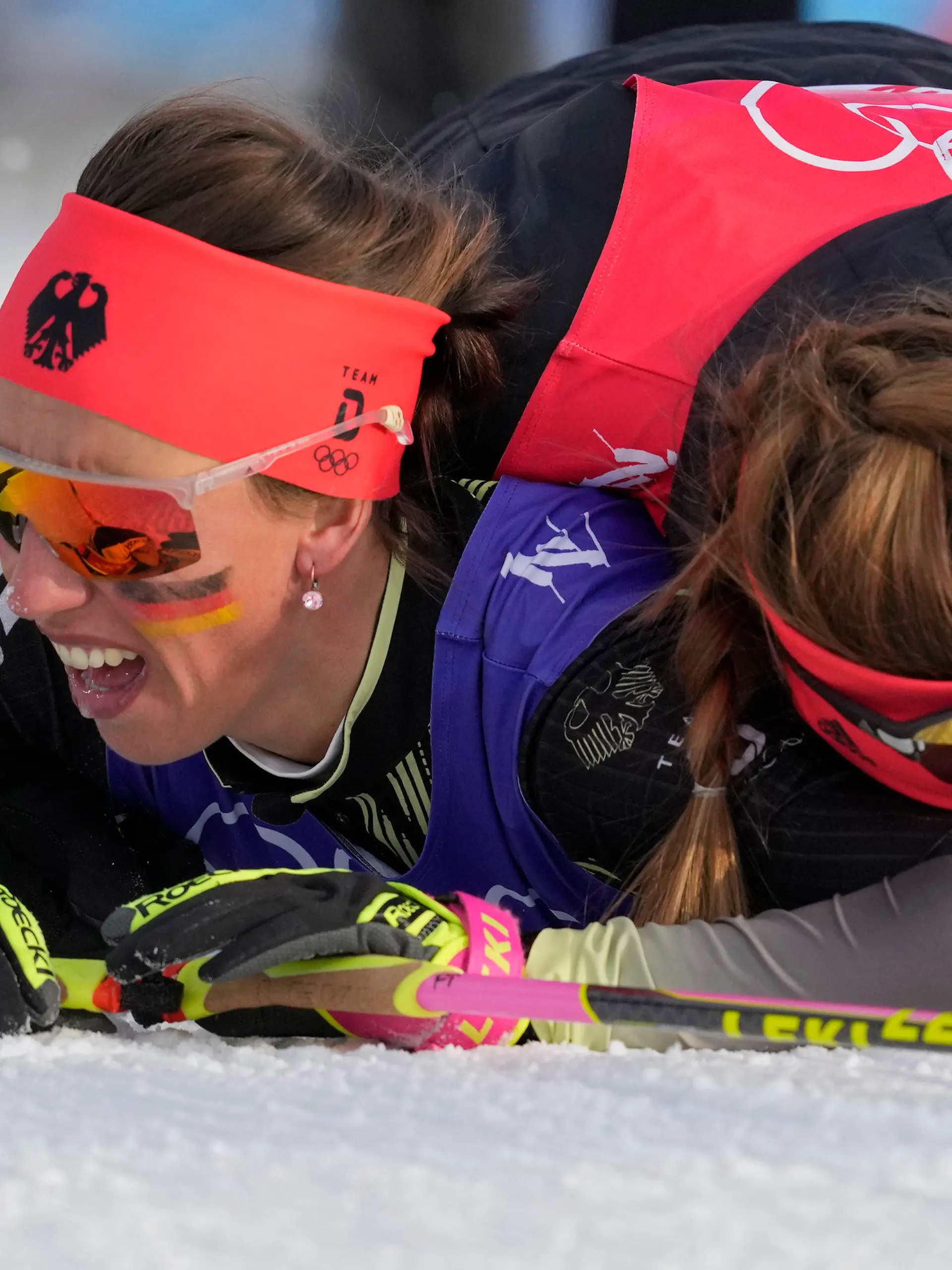 Katherine Sauerbrey, of Germany, right, embraces Sofie Krehl, of Germany, after finishing the women's 4 x 5km relay cross-country skiing competition at the 2022 Winter Olympics, Saturday, Feb. 12, 2022, in Zhangjiakou, China. (AP Photo/Aaron Favila)