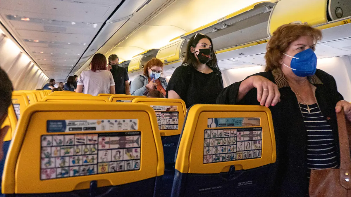 Passengers during the flight wear a facemask in the cabin. Flying during the Covid-19 Coronavirus pandemic inside a Boeing 737-800 aircraft of Ryanair low cost carrier with destination Chania in Crete Island, a popular holiday destination. Inside the airplane is mandatory to wear face masks for the passengers and the flight crew, air stewardess etc while people need a negative COVID test to board on the plane as a safety measure, while the aviation and tourism industry is struggling to return back to normality. Greece is trying to boost its tourism and give privileges to vaccinated against Covid-19 pandemic international tourists and locals, as the country is heavily depended from the tourism industry. Chania Airport, Greece on June 13, 2021 (Photo by Nicolas Economou/NurPhoto)