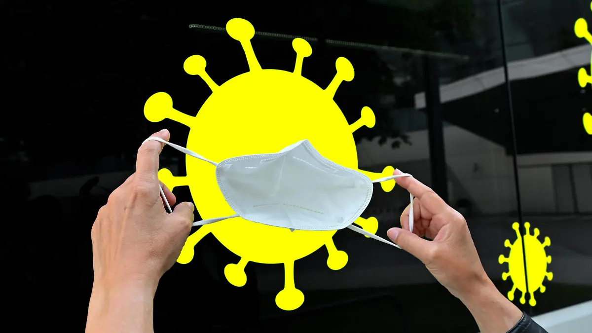  Viren-Abwehr. Hände mit FFP2 Schutzmaske vor einem Coronavirus Piktogramm als Symbolbild. München Bayern Deutschland *** virus defense hands with FFP2 protective mask in front of a coronavirus pictogram as symbol picture Munich Bavaria Germany Copyright: xRolfxPossx