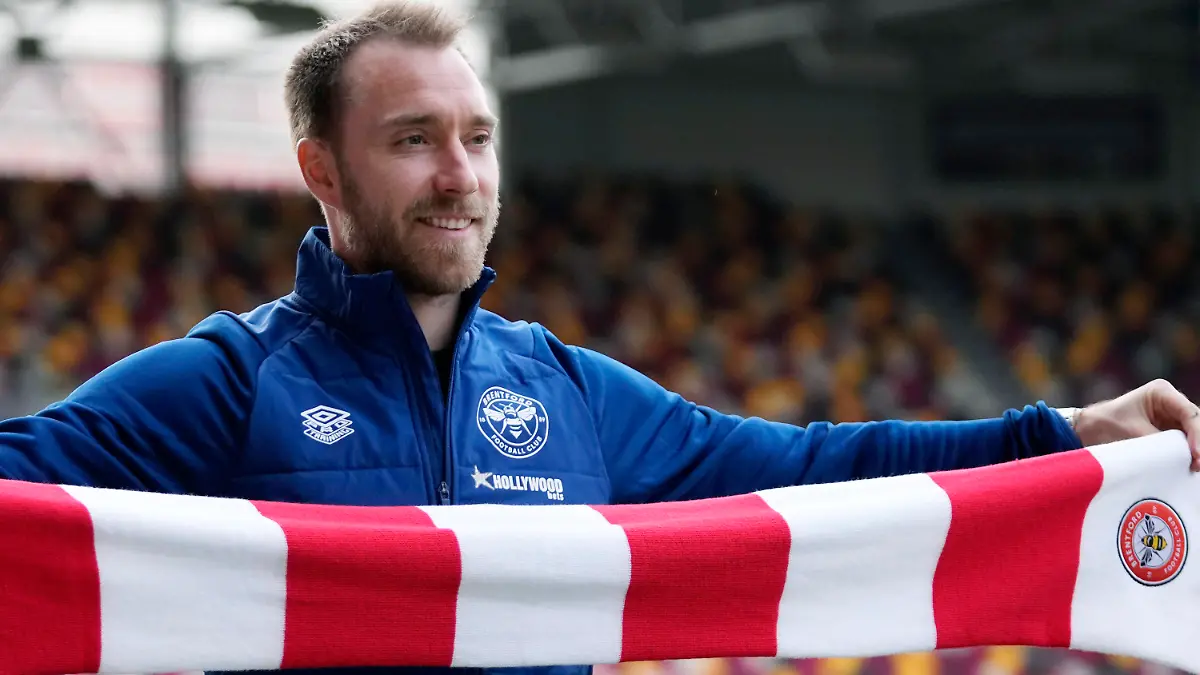 Brentford's newly signed Danish player Christian Eriksen smiles as he poses for photographs during his official presentation at the Community Stadium, in London, Friday, Feb. 11, 2022. Eriksen has signed with Brentford until the end of the season, almost eight months after collapsing from cardiac arrest at the European Championship. It will be a remarkable playing comeback to the English Premier League for the Denmark playmaker, who has said he was essentially dead for five minutes after collapsing in the opening Euro 2020 game against Finland. (AP Photo/Matt Dunham)