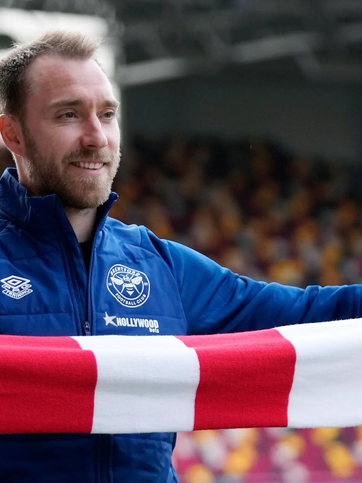 Brentford's newly signed Danish player Christian Eriksen smiles as he poses for photographs during his official presentation at the Community Stadium, in London, Friday, Feb. 11, 2022. Eriksen has signed with Brentford until the end of the season, almost eight months after collapsing from cardiac arrest at the European Championship. It will be a remarkable playing comeback to the English Premier League for the Denmark playmaker, who has said he was essentially dead for five minutes after collapsing in the opening Euro 2020 game against Finland. (AP Photo/Matt Dunham)