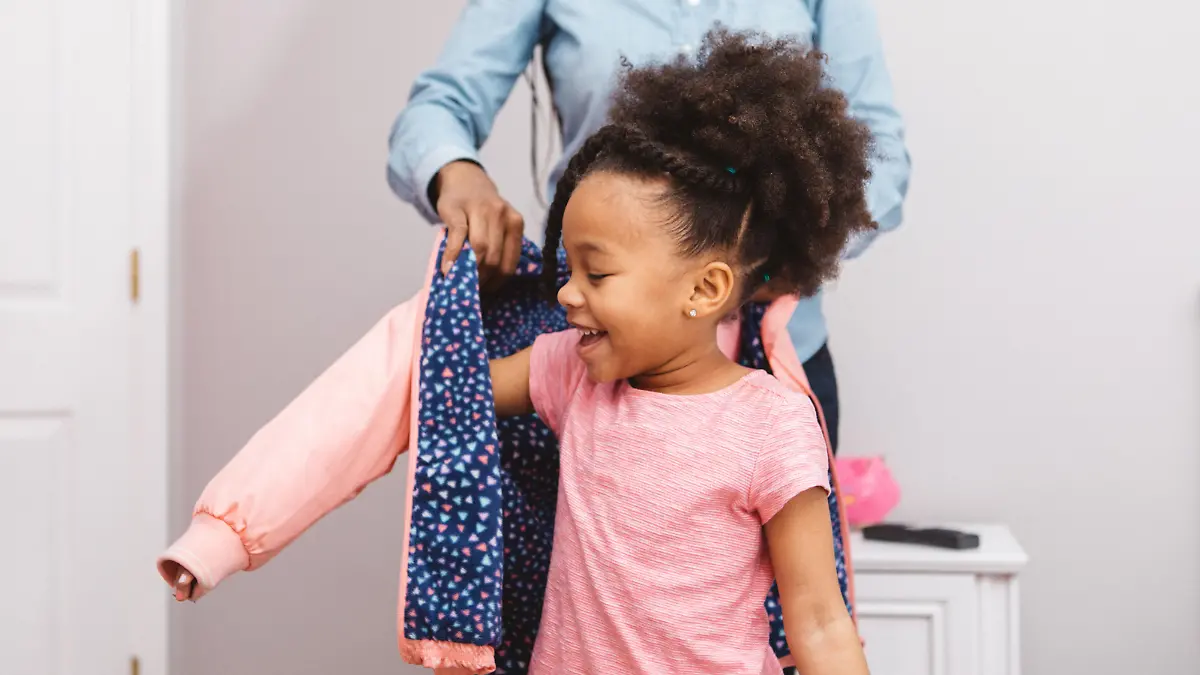 Little girl putting on her jacket to head out.
