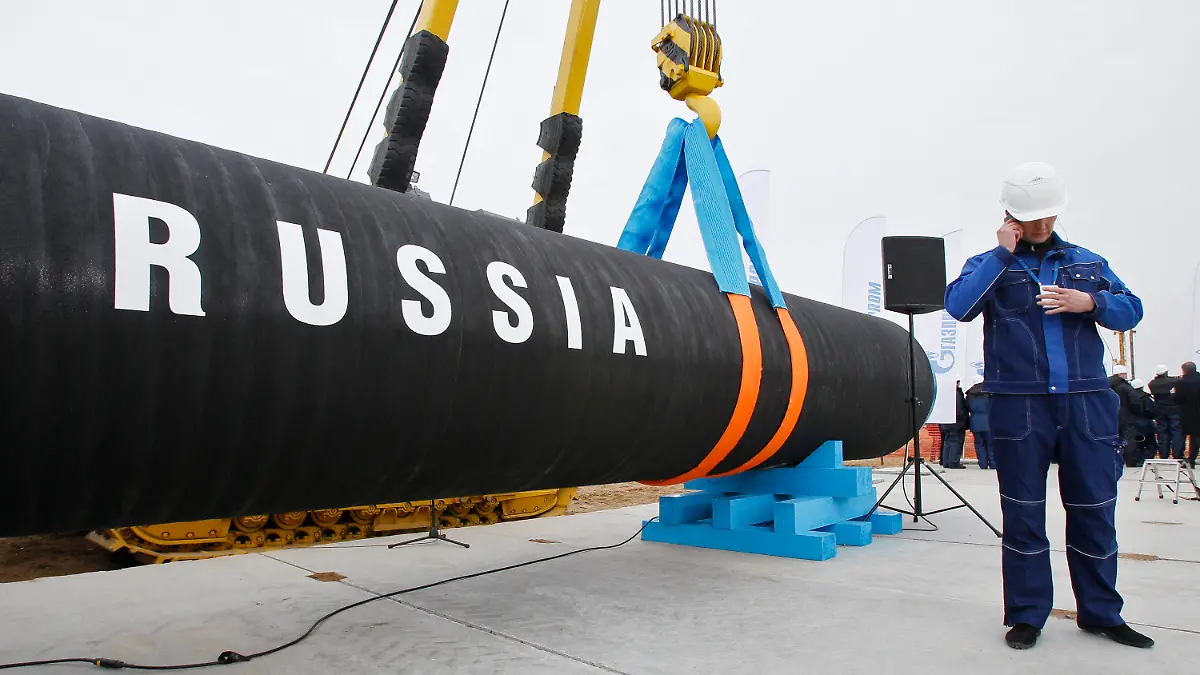 FILE - A Russian construction worker speaks on a mobile phone during a ceremony marking the start of Nord Stream pipeline construction in Portovaya Bay some 170 kms (106 miles) north-west from St. Petersburg, Russia on April 9, 2010. Fears are rising about what would happen to Europe's energy supply if Russia were to invade Ukraine and then shut off its natural gas in retaliation for U.S. and European sanctions. (AP Photo/Dmitry Lovetsky, File)