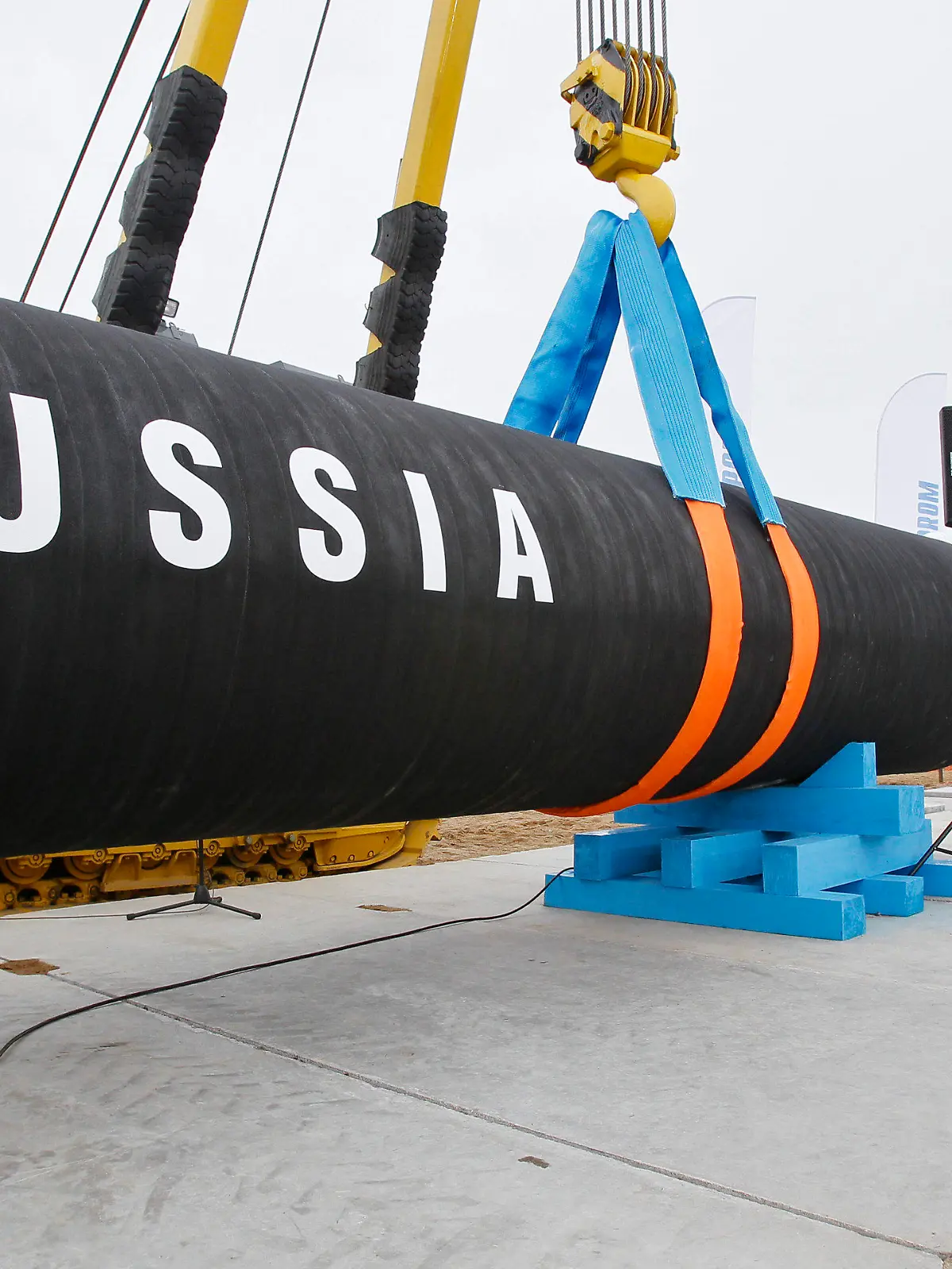 FILE - A Russian construction worker speaks on a mobile phone during a ceremony marking the start of Nord Stream pipeline construction in Portovaya Bay some 170 kms (106 miles) north-west from St. Petersburg, Russia on April 9, 2010. Fears are rising about what would happen to Europe's energy supply if Russia were to invade Ukraine and then shut off its natural gas in retaliation for U.S. and European sanctions. (AP Photo/Dmitry Lovetsky, File)