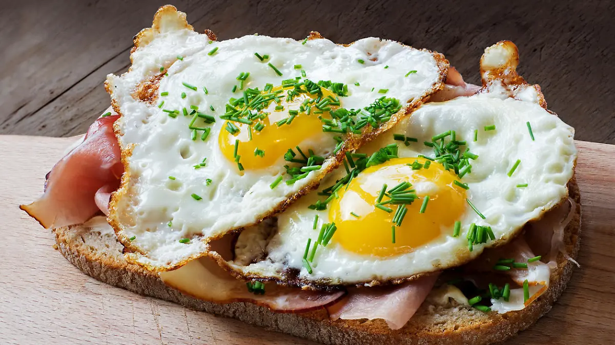 slice of rustic bread with ham or bacon and fried egg, typical in germany called strammer max