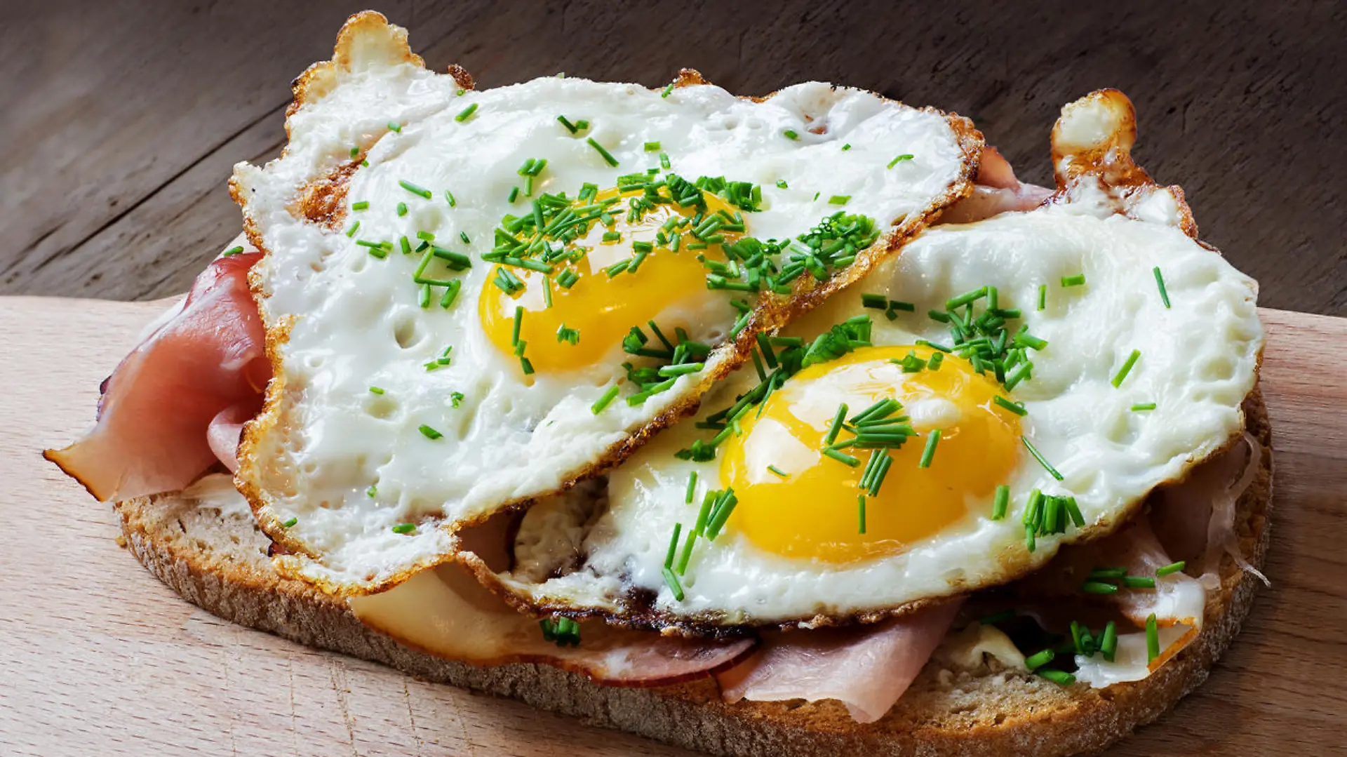 slice of rustic bread with ham or bacon and fried egg, typical in germany called strammer max