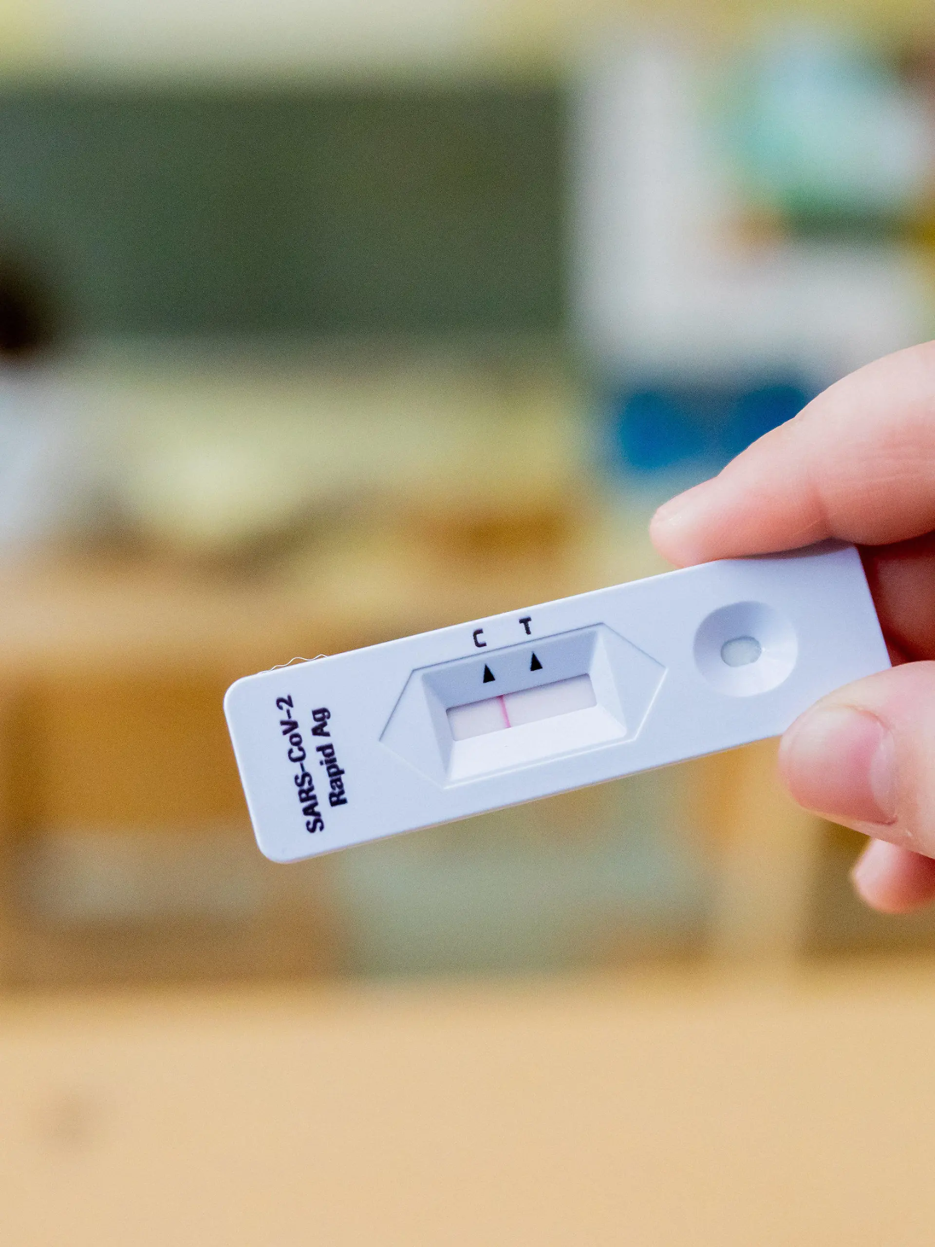 ARCHIV - 14.04.2021, Berlin: Ein Schüler hält bei einem Probelauf mit Corona-Schnelltests an der Grundschule in der Köllnischen Heide in Berlin-Neukölln seinen negativen Test in die Kamera. In den ersten zwei Wochen nach den Winterferien sind tägliche Tests an Schulen Pflicht, danach nicht mehr. (zu dpa «Elternvertreter: Tägliche Tests an Schulen fortsetzen») Foto: Christoph Soeder/dpa +++ dpa-Bildfunk +++