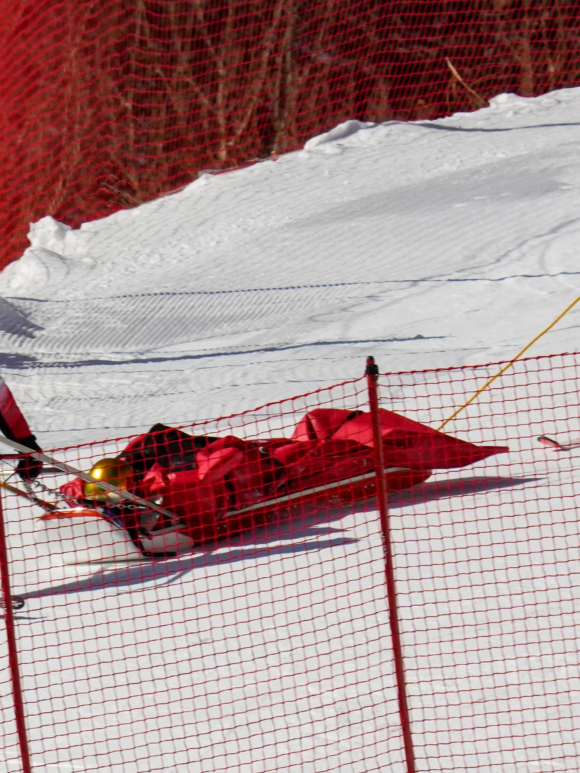 Paramedics carry down Dominik Schwaiger, of Germany, after he fell during the men's downhill at the 2022 Winter Olympics, Monday, Feb. 7, 2022, in the Yanqing district of Beijing.(AP Photo/Luca Bruno)