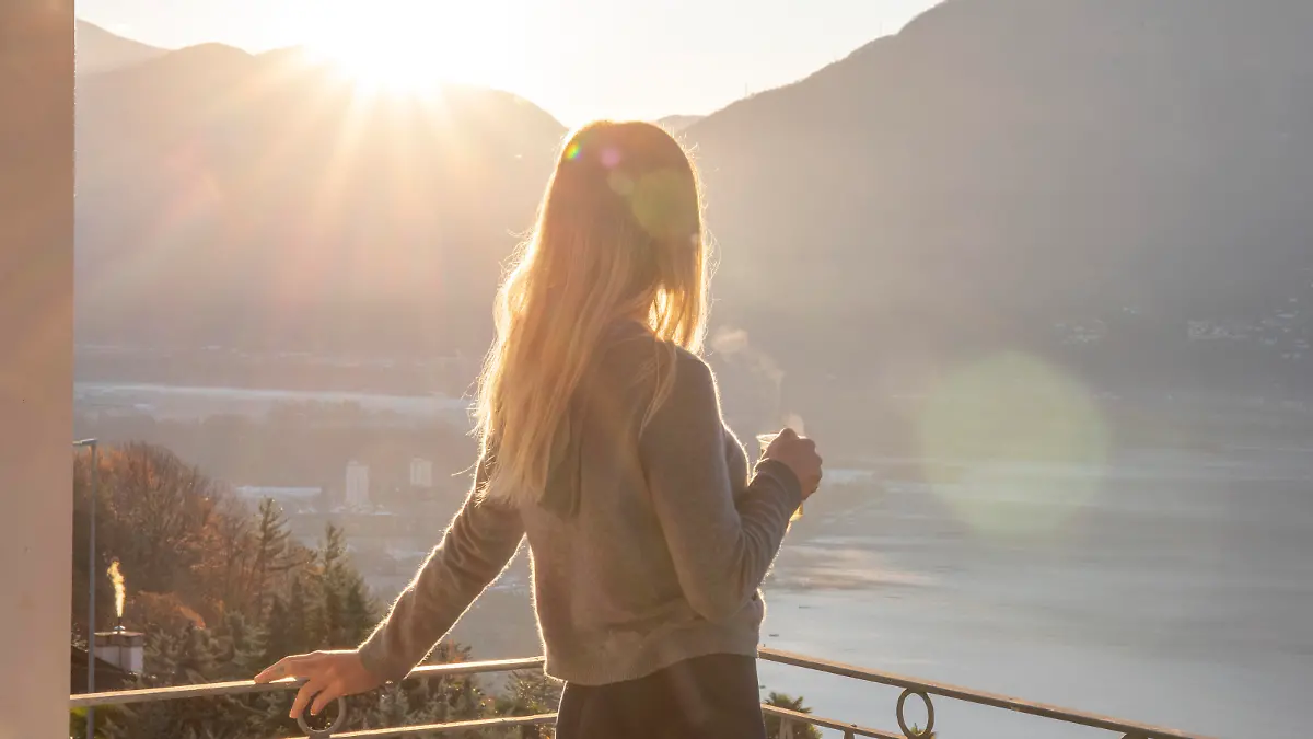 She sips on tea and looks off to distant Lake Maggiore and Swiss Alps