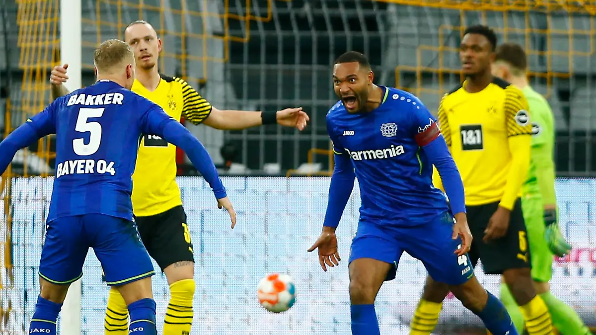 Soccer Football - Bundesliga - Borussia Dortmund v Bayer Leverkusen - Signal Iduna Park, Dortmund, Germany - February 6, 2022 Bayer Leverkusen's Jonathan Tah celebrates scoring their fourth goal with Mitchel Bakker REUTERS/Thilo Schmuelgen DFL REGULATIONS PROHIBIT ANY USE OF PHOTOGRAPHS AS IMAGE SEQUENCES AND/OR QUASI-VIDEO.