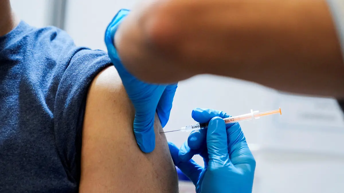 A local resident receives a booster shot of the Moderna coronavirus disease (COVID-19) vaccine at a mass vaccination center operated by Japanese Self-Defense Force, in Tokyo, Japan, January 31, 2022. Eugene Hoshiko/Pool via REUTERS