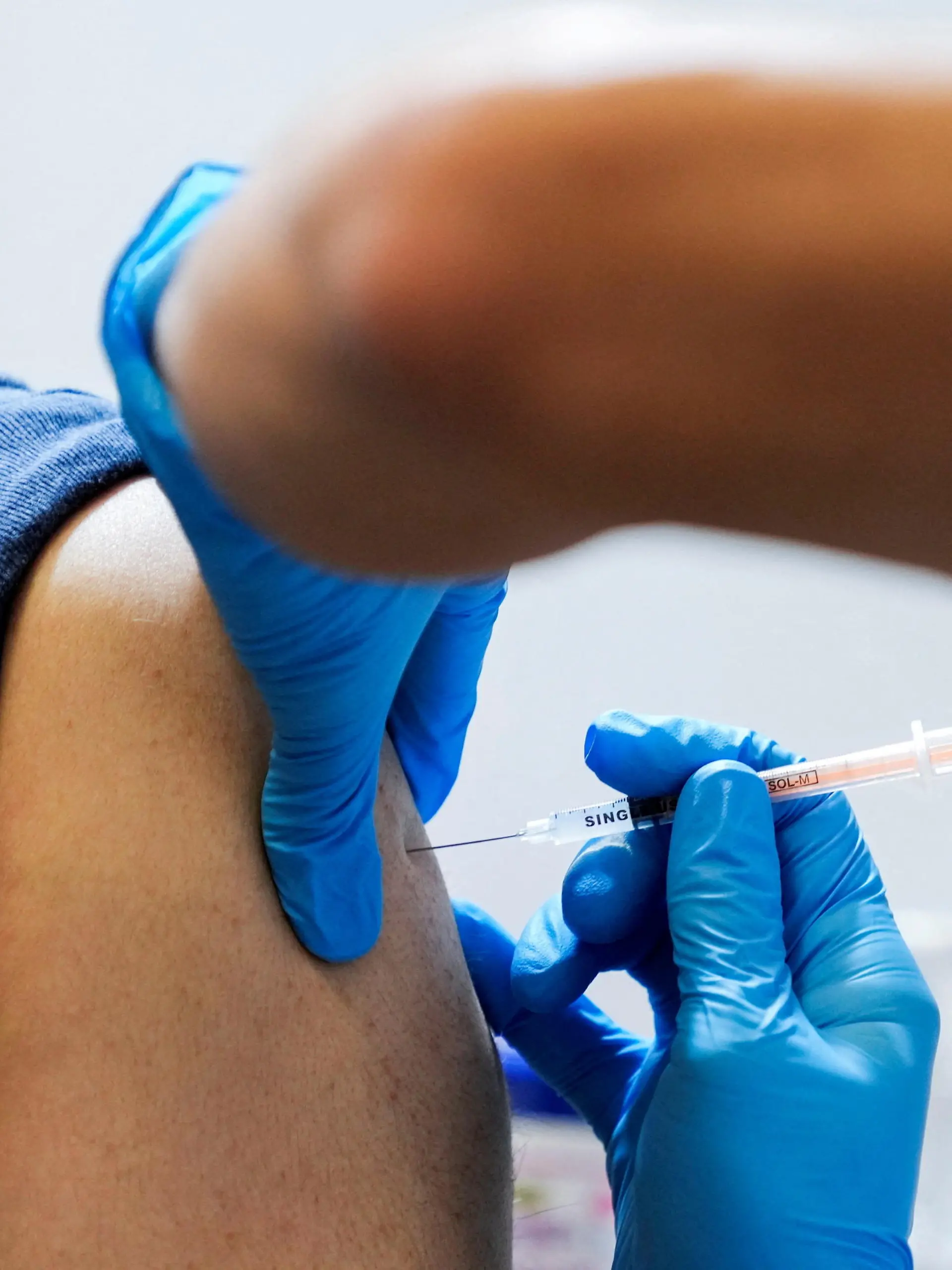 A local resident receives a booster shot of the Moderna coronavirus disease (COVID-19) vaccine at a mass vaccination center operated by Japanese Self-Defense Force, in Tokyo, Japan, January 31, 2022. Eugene Hoshiko/Pool via REUTERS