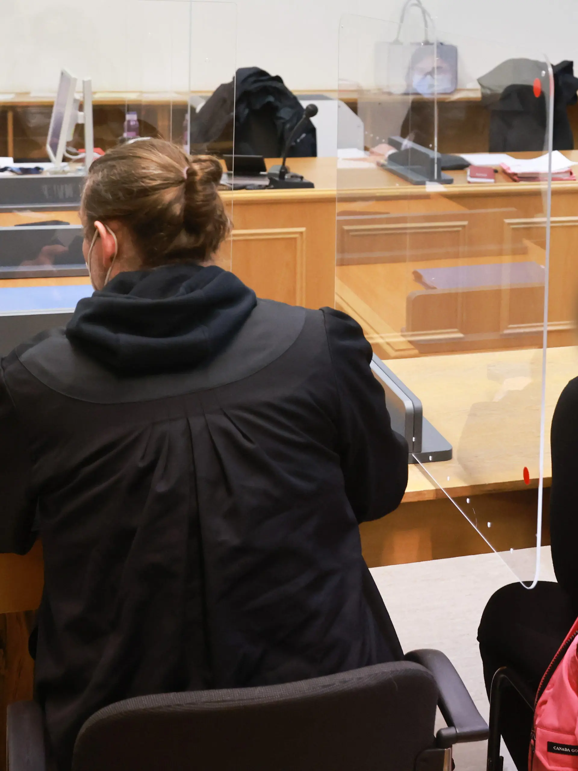03.02.2022, Hamburg: Zwei angeklagte Frauen warten in einem Gerichtssaal im Strafjustitzgebäude in Hamburg auf den Beginn der Verhandlung. Mittig sitzt ein Anwalt. Die beiden Frauen sollen unter anderem im Juli 2019 einem Kunden Geld, Handy und Bankkarten abgenommen haben. Foto: Ulrich Perrey/dpa - ACHTUNG: Person(en) wurde(n) aus rechtlichen Gründen gepixelt +++ dpa-Bildfunk +++