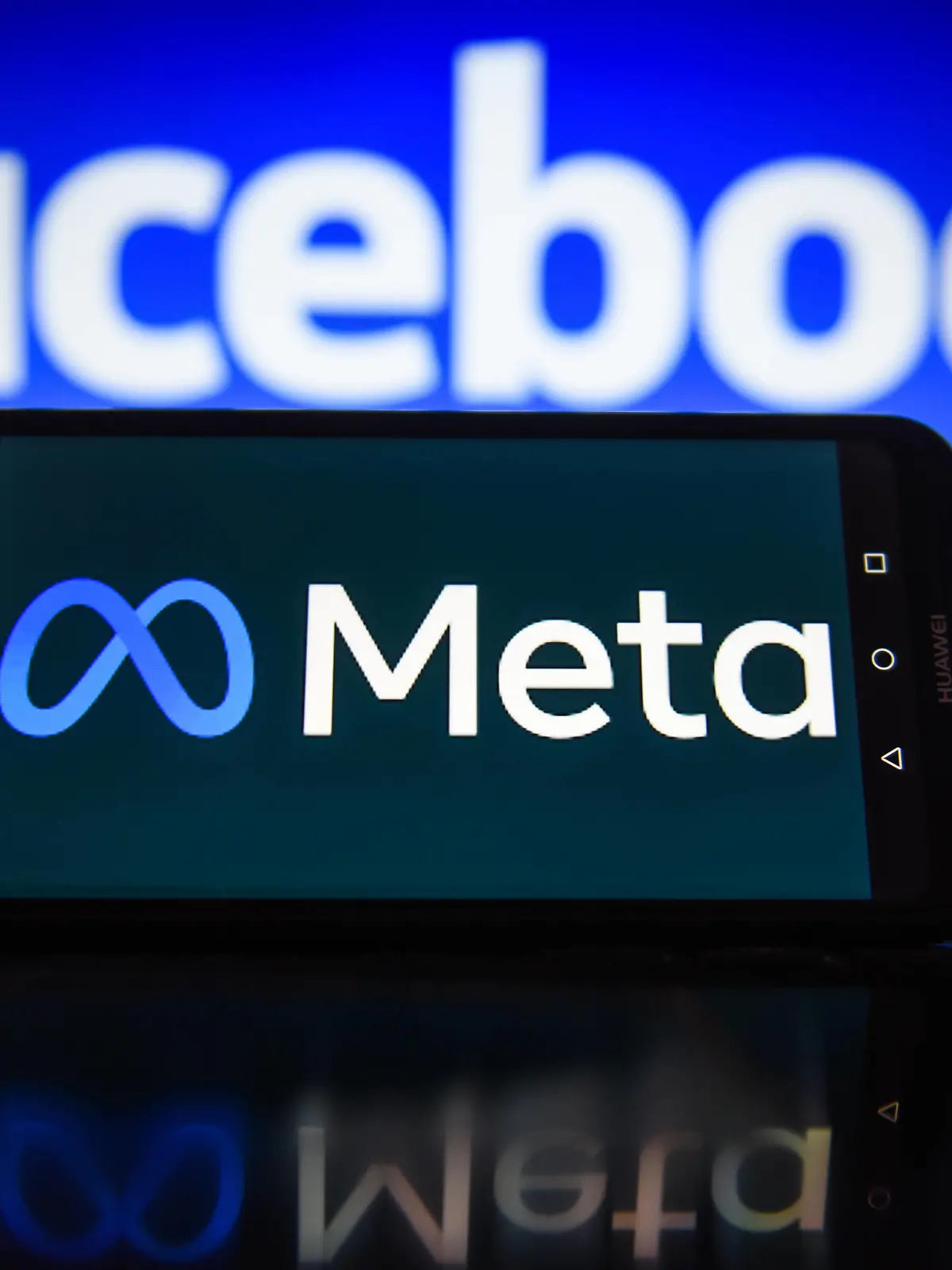  January 3, 2022, Krakow, Poland: In this photo illustration a Meta logo seen displayed on a smartphone with Facebook logo in the background. Krakow Poland - ZUMAs197 20220103_zab_s197_027 Copyright: xOmarxMarquesx
