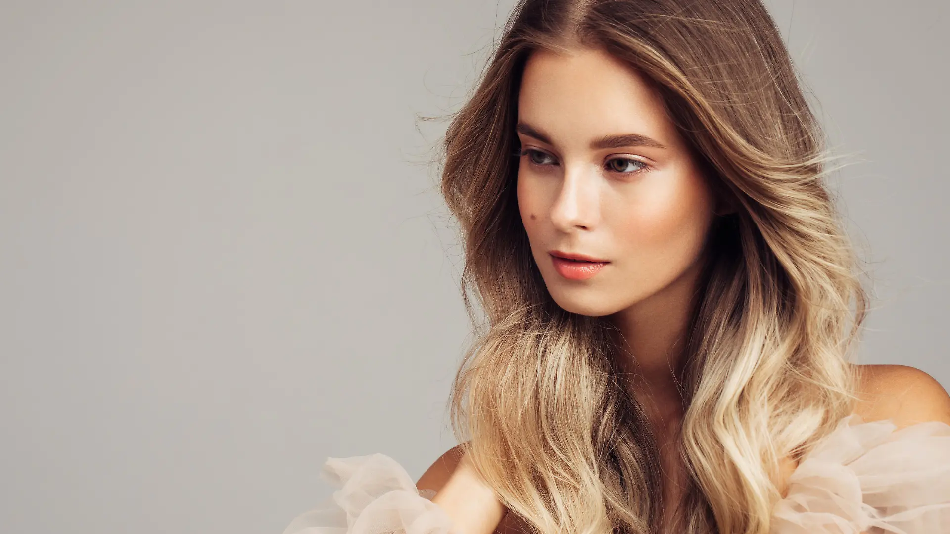 Portrait of gorgeous young woman with elegant make up and perfect golden hairstyle