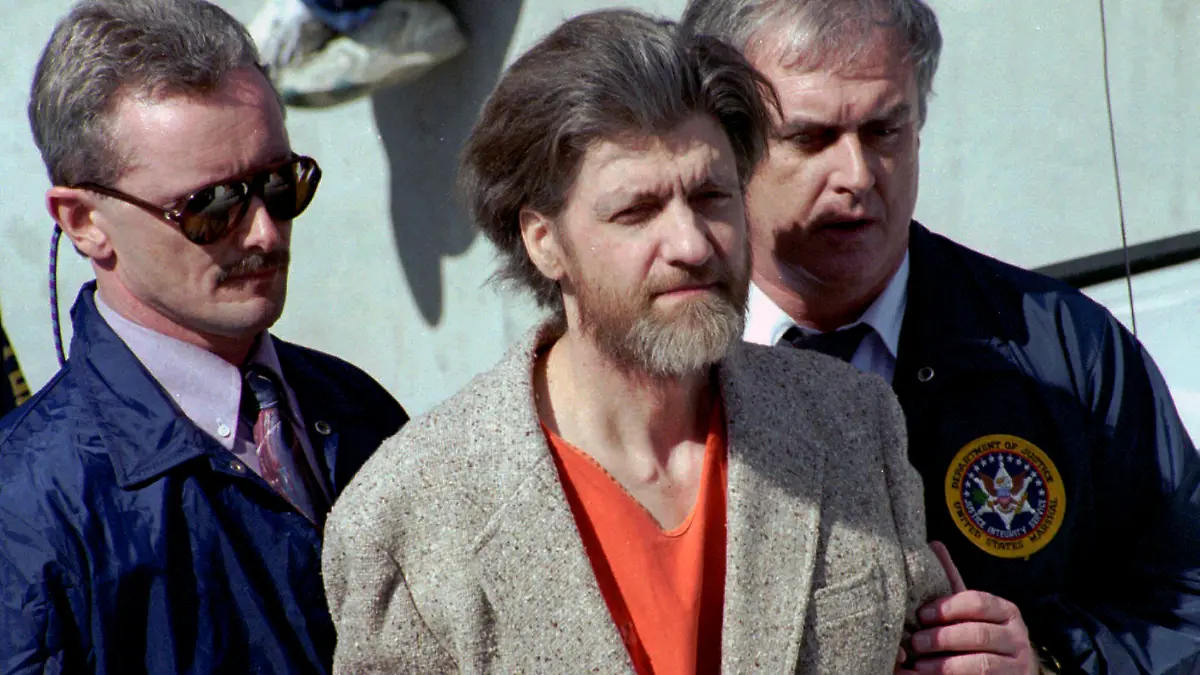 FILE - Theodore "Ted" Kaczynski is flanked by federal agents as he is led to a car from the federal courthouse in Helena, Mont., April 4, 1996. A spokesperson for the Bureau of Prisons on Saturday, June 10, 2023, told The Associated Press that Kaczynski, known as the “Unabomber,” has died in federal prison. The cause of death was not immediately known. (AP Photo/John Youngbear, File)