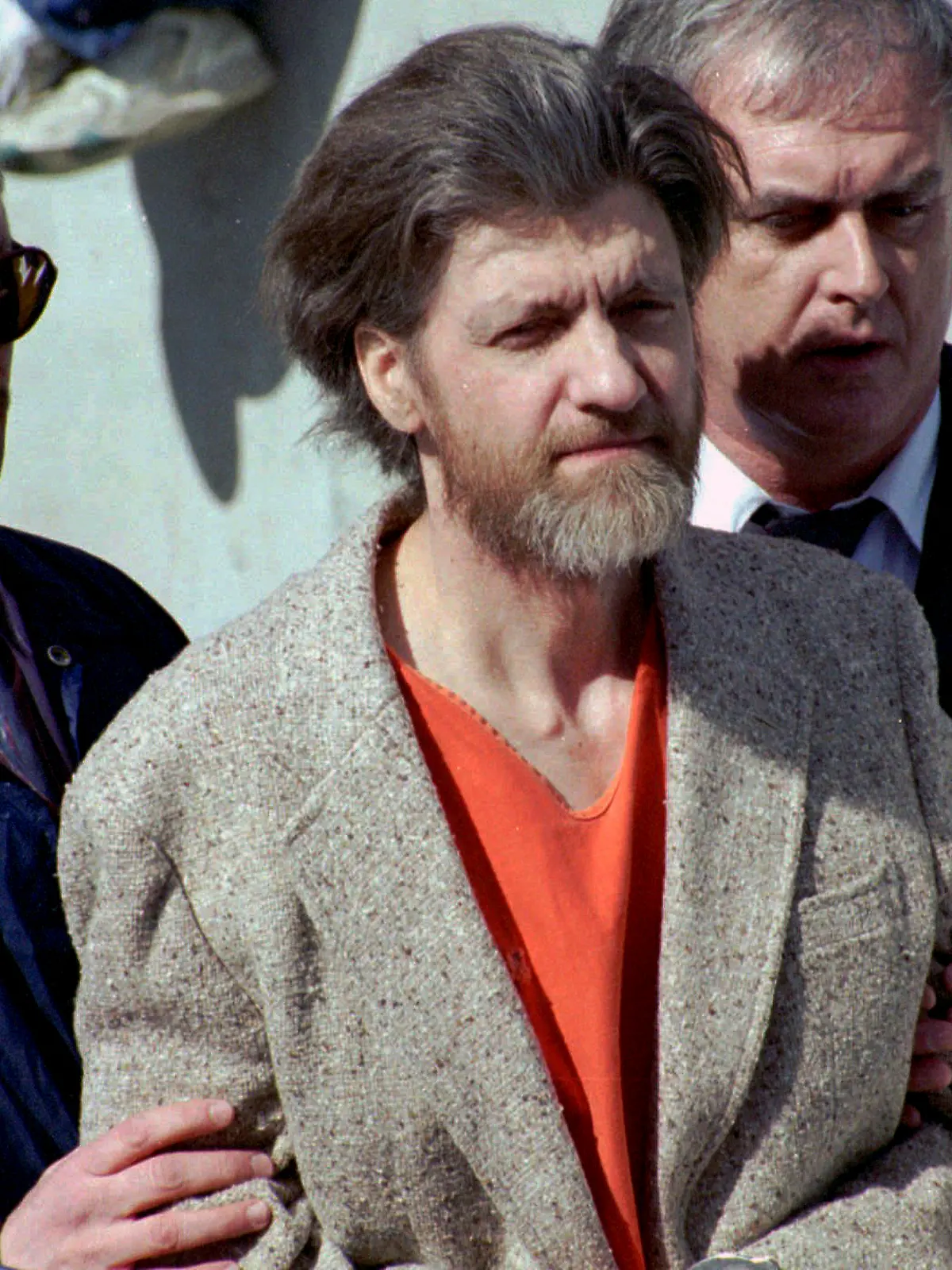 FILE - Theodore "Ted" Kaczynski is flanked by federal agents as he is led to a car from the federal courthouse in Helena, Mont., April 4, 1996. A spokesperson for the Bureau of Prisons on Saturday, June 10, 2023, told The Associated Press that Kaczynski, known as the “Unabomber,” has died in federal prison. The cause of death was not immediately known. (AP Photo/John Youngbear, File)