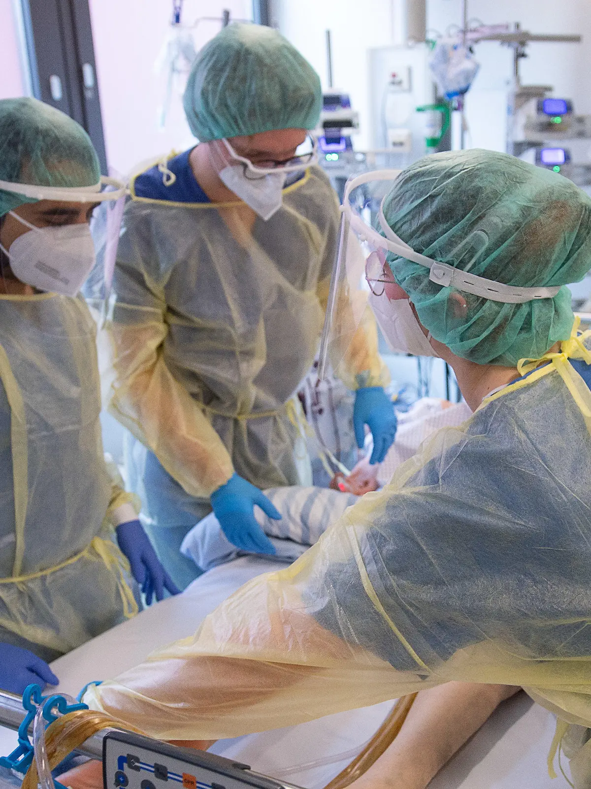 ARCHIV - 05.01.2022, Hessen, Offenbach am Main: Pfleger und Pflegerinnen sowie eine Ärztin kümmern sich auf der Intensivstation für Corona-Patienten am Sana Klinikum Offenbach um einen Patienten. «Wenn im Krankenhaus die halbe Belegschaft zu Hause bleiben muss, weil sie in Quarantäne ist, ist auch ein normales Aufkommen schon schwer zu bewältigen. Dasselbe gilt für die Praxen - auch Ärzte und medizinische Fachangestellte können sich infizieren und in Quarantäne müssen, auch da wird das Personal knapp werden.» sagte der Chef der Kassenärztlichen Bundesvereinigung, Andreas Gassen. (zu dpa: «Ärztevertreter warnen vor Personalengpässen wegen Omikron-Welle») Foto: Sebastian Gollnow/dpa +++ dpa-Bildfunk +++