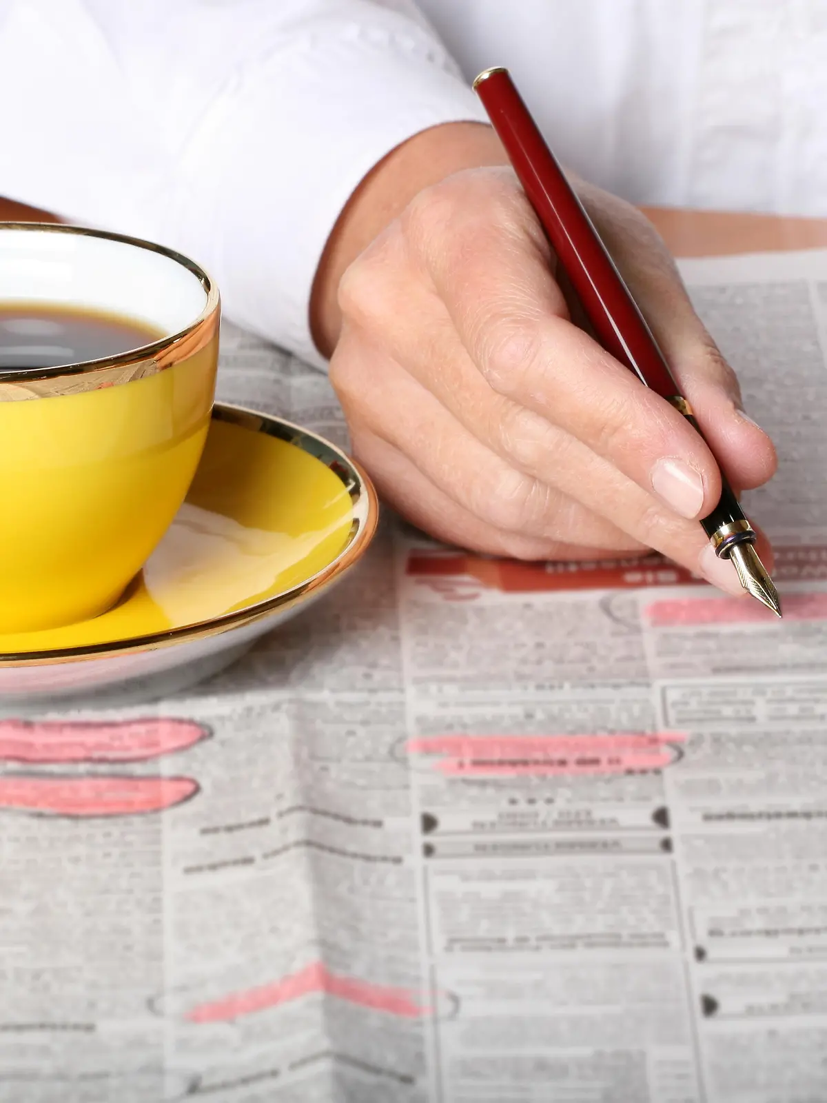 person searching for ads and job in the newspaper