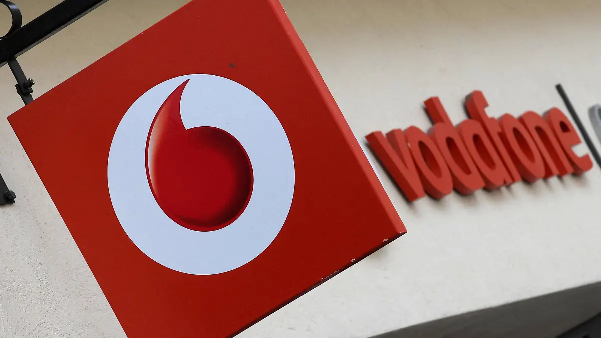FILE PHOTO: Branding hangs outside a Vodafone shop in Oxford, Britain, May 16, 2017. REUTERS/Toby Melville/File Photo
